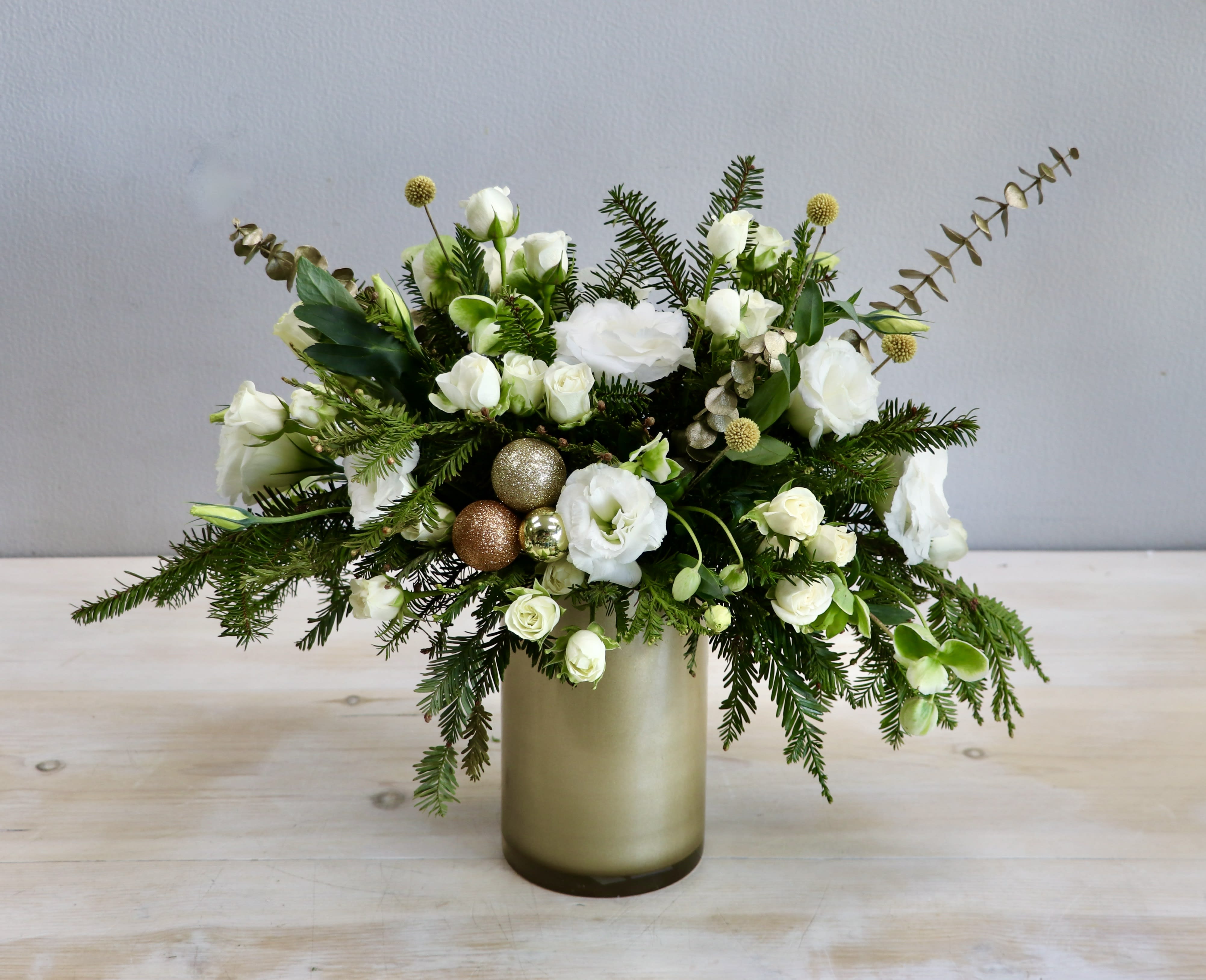 Champagne Sparkle - Glendale Florist - The "Champagne Sparkle Holiday Arrangement" exudes elegance and festivity, blending ivory and cream blooms with golden accents to create a sophisticated celebration centerpiece.