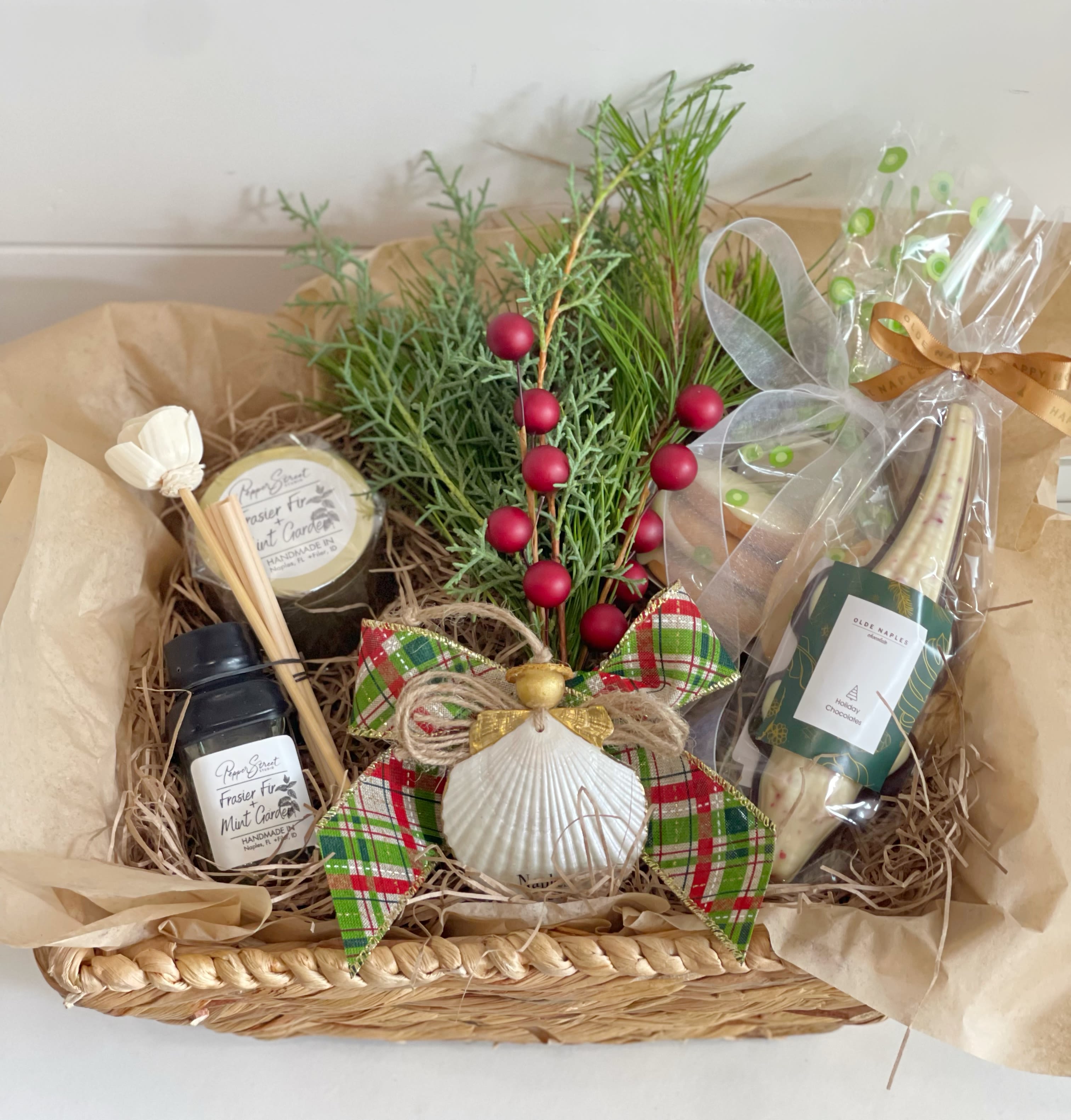 Smells like Christmas - Smells like Christmas: -angel shell ornament made by local artist  -Frazier fur and garden mint travel candle locally made by Pepper Street Studio  -Frazier fur and garden mint reed room diffuser locally made by Pepper Street Studio  -Kristi’s key lime cookies  -Chocolate alligator from Olde Naples Chocolate’s  -fresh pine bundle  -in nice reusable wicker basket 