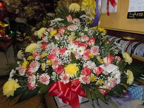 TB34 Sympathy Basket - A Mixture of white and yellow daisies, white carnations tipped red, white roses tipped red, yellow fuji mums, white alstromaria, baby's breath, greens and red bow  Banner - $15.00 + extra  Substitutions may apply due to flower availability