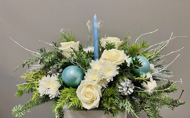 Winter Wishes - Blue and white are the icy colors that Winter Wishes are made up of. A blue candle enclosed in a hurricane glass adds elegance to this gorgeous centerpiece. 