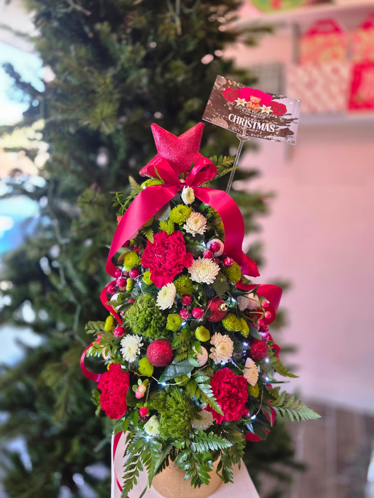 Christmas Holiday  Flower Tree - The perfect gift for this Christmas holiday season, give a touch of Christmas to that special person. You can add a magical touch to your Christmas tree by selecting the LED lights found in the accessories section of the arrangement.
