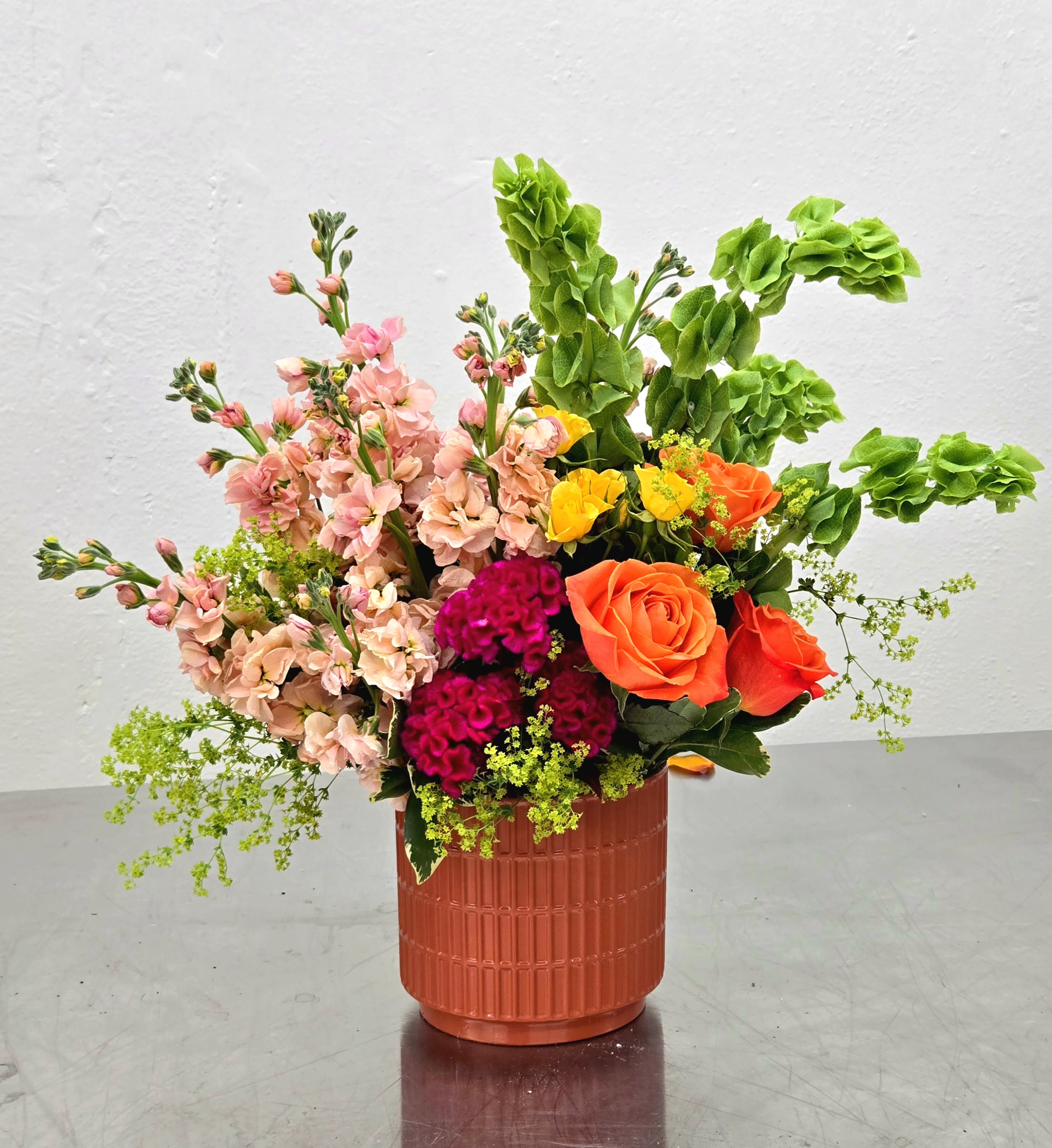 Fabulously Fun - Such a happy and cheerful arrangement in tones of Orange, Pinks, Greens &amp; Yellows.  Perfect for so many occasions. This can be made in 3 different sizes.  *Size shown is the deluxe size.  Created by The Impeccable Poppy in Sherman, TX.
