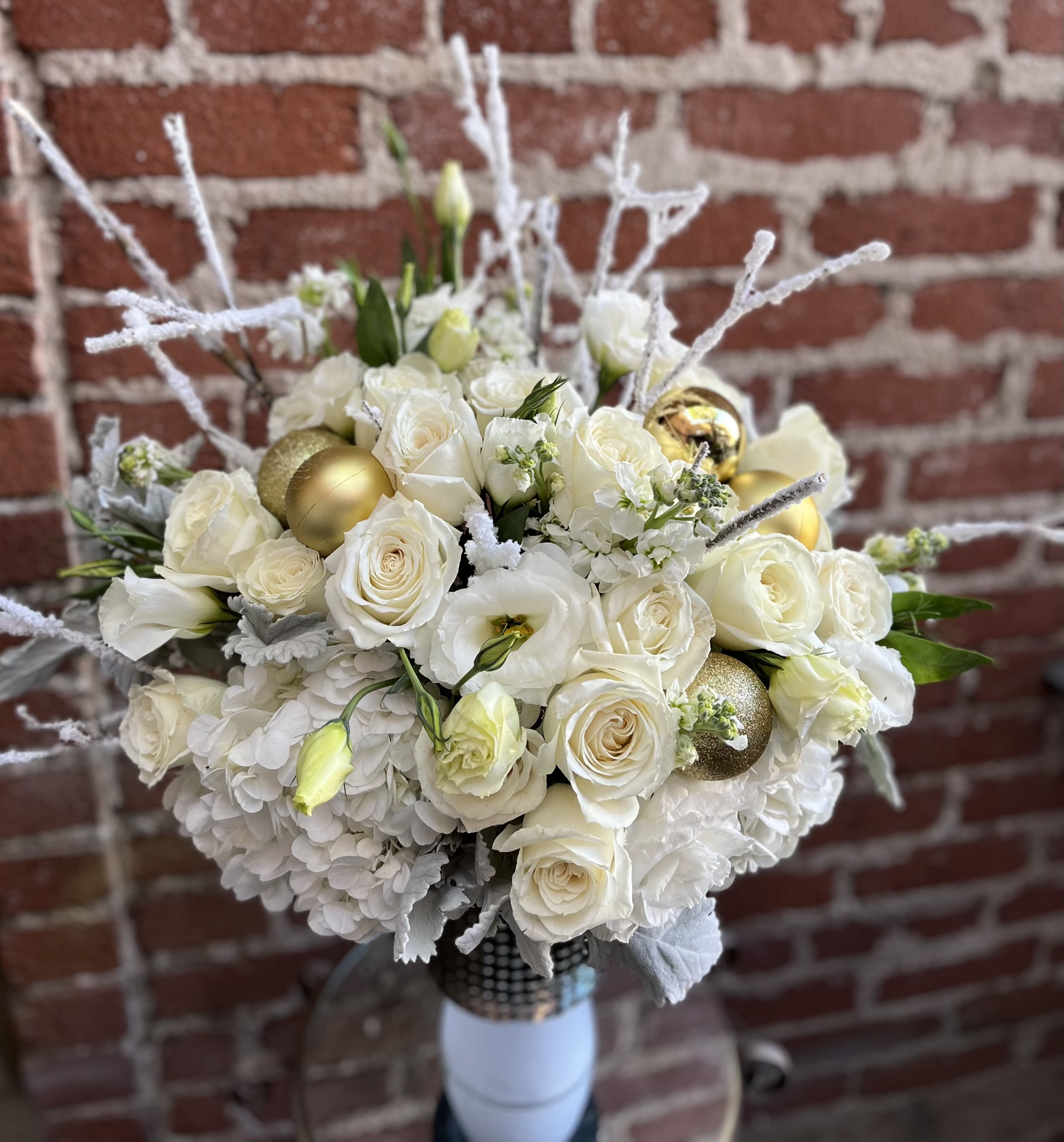 Winter Wonderland- Pasadena Florist - Introducing "Winter Wonderland" Christmas Flower Arrangement – a breathtaking blend of festive blooms that brings the magic of the season into your home. Elevate your holiday décor with this enchanting arrangement that captures the essence of winter's charm.  