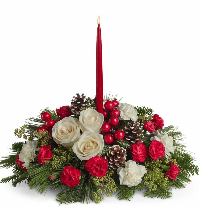 Christmas Aglow - The soft light of one simple red candle. The beauty of a gorgeous, sprawling Christmas arrangement of roses and carnations laced with pinecones, berries and more. What a beautifully sensational centerpiece! Imagine it on your table.  Includes white roses, white carnations and red miniature carnations accented with eucalyptus, noble fir, white pine, pine cones and red berries. Comes with one 12" red taper candle.