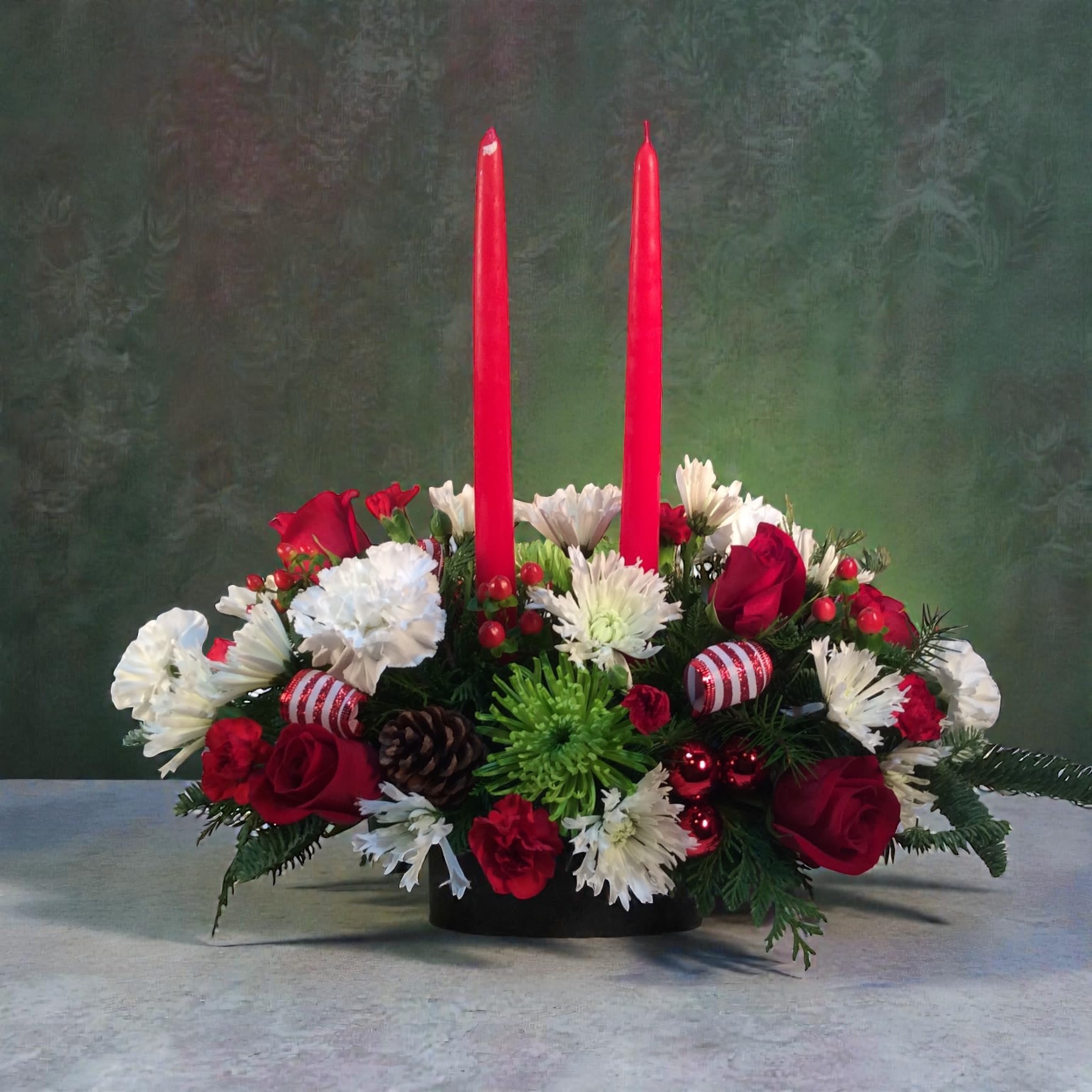 Joyful Holiday - A festive holiday centerpiece with candles. A perfect accent for a holiday gathering using the season's freshest flowers. 