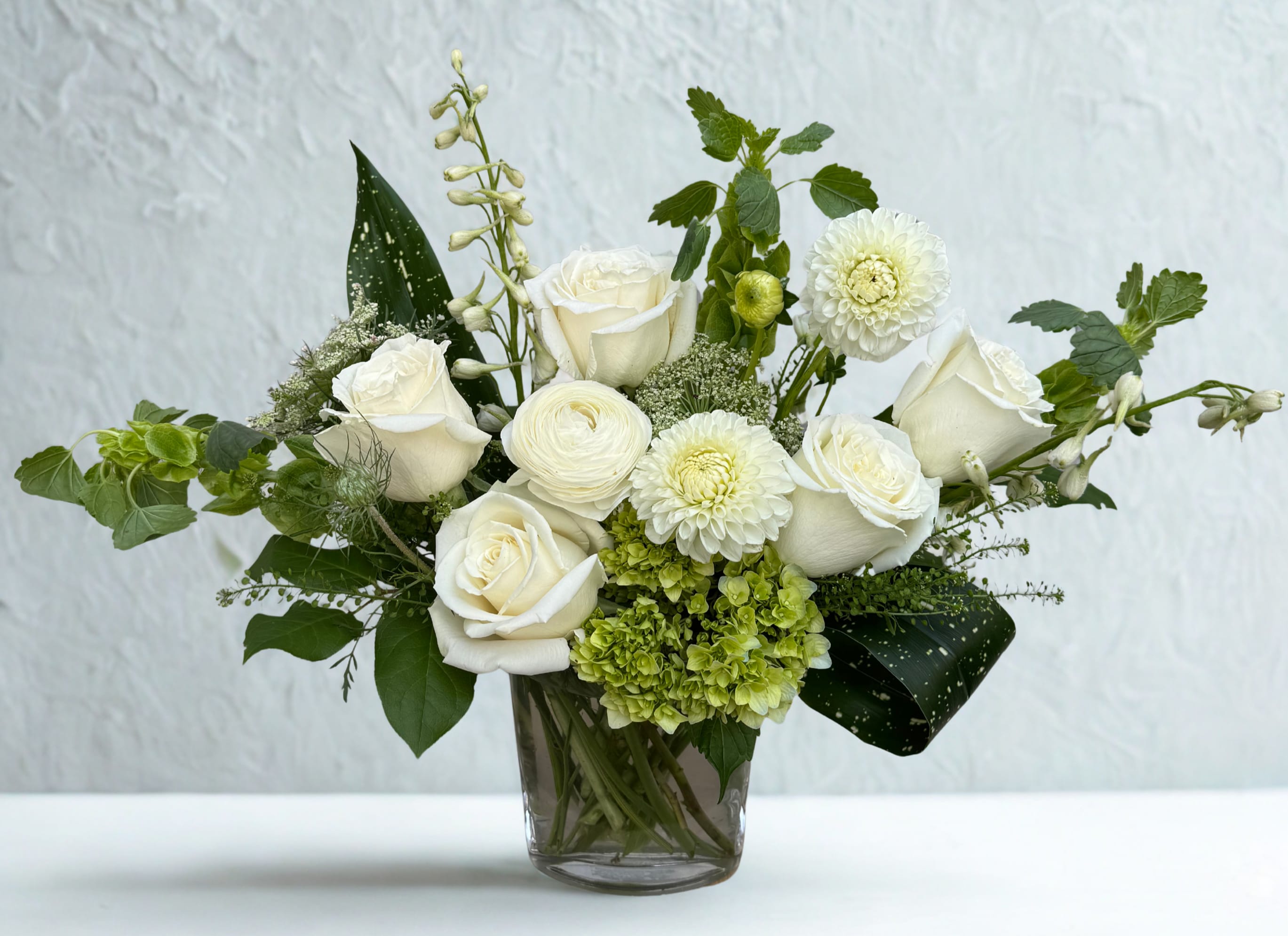 Hillside's White Garden Harmony - A fresh white-and-green arrangement of roses, dahlia, and hydrangea, artfully styled for a clean, timeless look. Perfect for any occasion where elegance is key.
