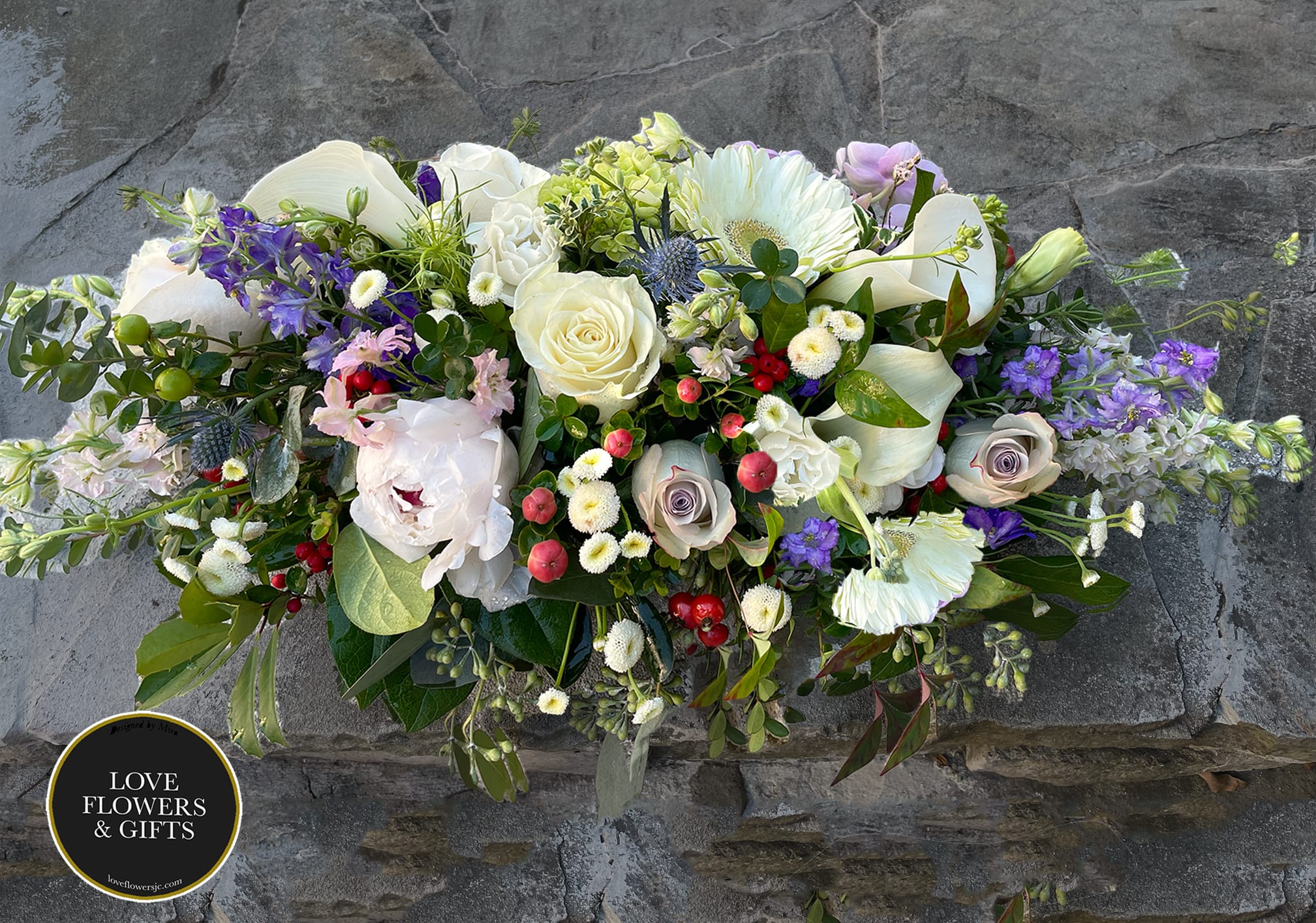 December (Centerpiece) - A beautiful low holiday centerpiece of natural style of textures of winter . Great gift for early holiday dinner and gatherings. There is also a matching arrangement here: https://loveflowersjc.com/johns-creek-love-flowers-and-gifts-jc/december.html  Measures appx: 21&quot; by 12