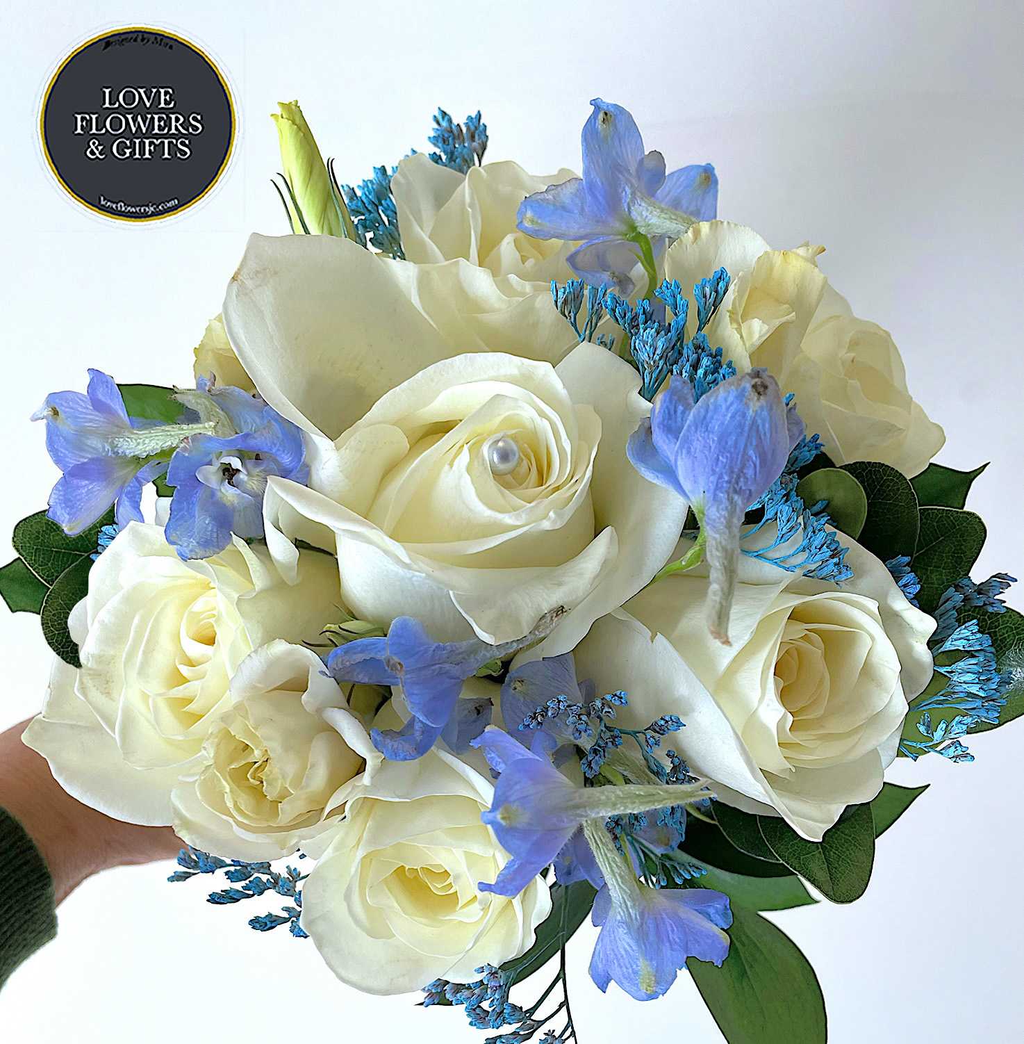 White with Blue (Handheld Prom Bouquet) - Handheld Bouquets have become very popular, this one is made with whites and hints of blues, wrapped in blue satin ribbon. Perfect for Prom, Homecoming, formal dances and more.  STANDARD is just the handheld bouquet DELUXE is the handheld bouquet AND a matching boutonierre.  If you would like us to switch out certain flower/ribbon color, please write at &quot;Florists Instructions&quot; at Checkout (Depending on availability, filler flowers and greenery may vary)