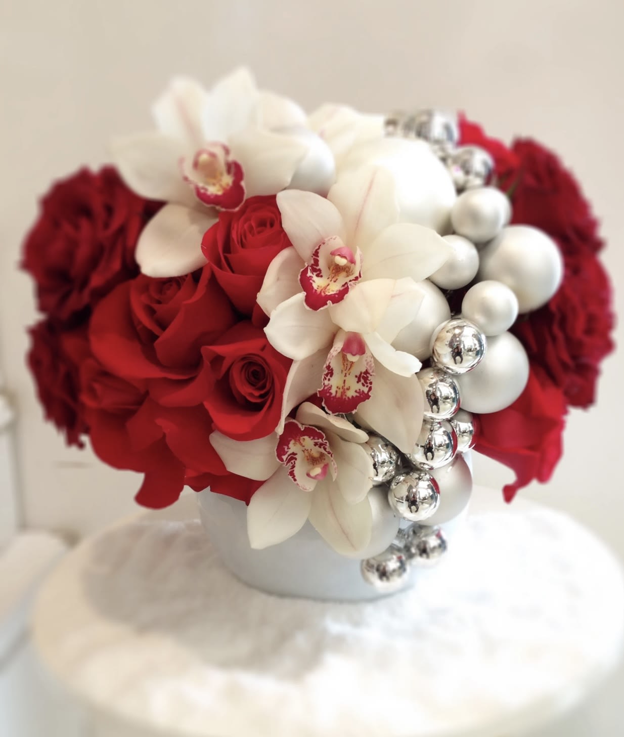 Jingle Bells - Festive arrangement with gorgeous roses and Orchids in beautiful ceramic vase