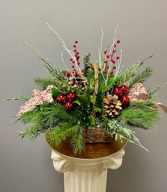 SILENT NIGHT - A brown basket filled with a lush selection of assorted winter greens, including white pine, juniper, cedar, and balsam. Accented with ribbon, berries, white birch branches and more. This will last long after the holiday season is over.
