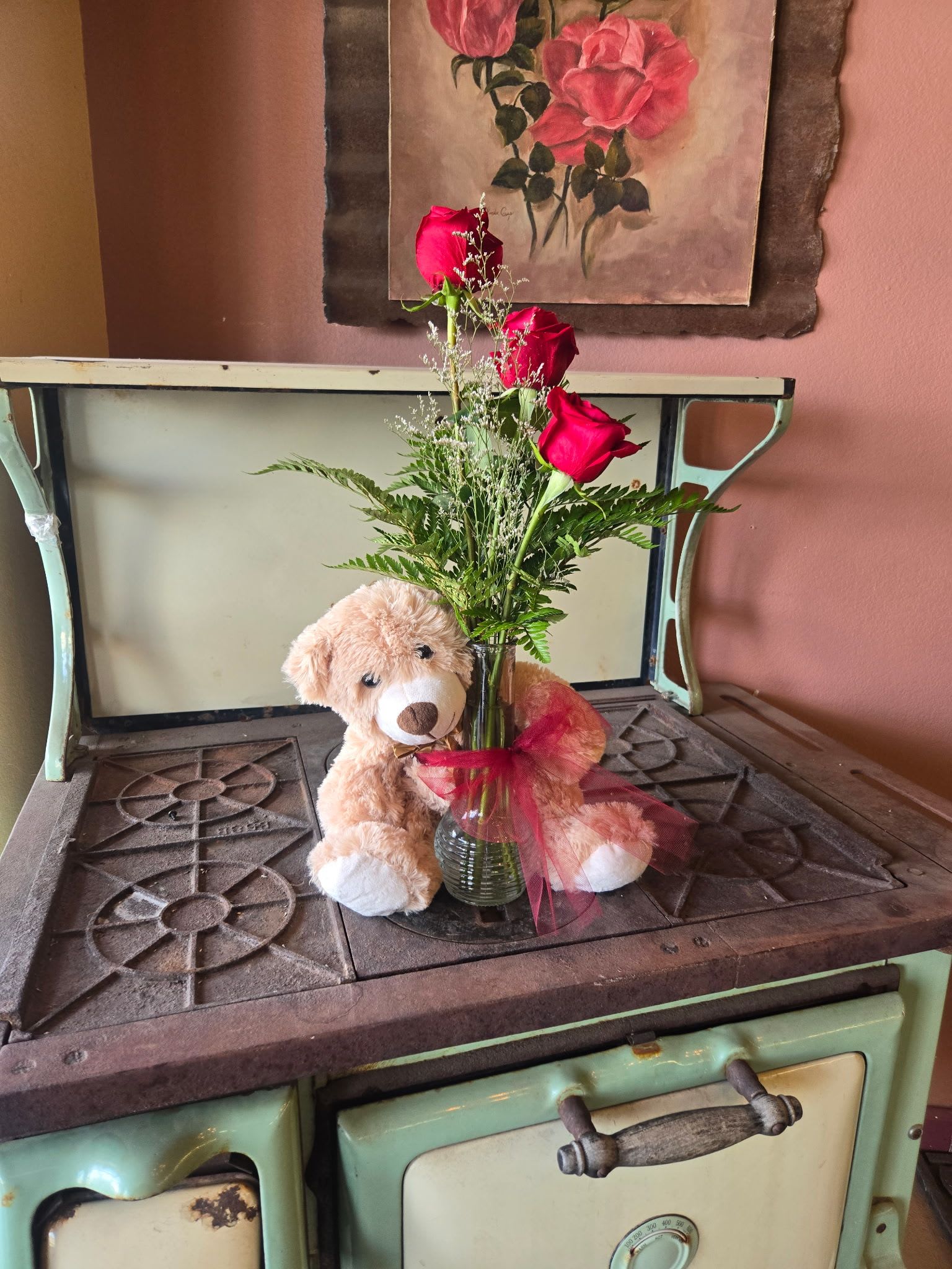 Bear Hug Trio - Send an adorable little bear with enchanting flowers and someone special will think you're just as sweet as can be. Three roses and Limonium lacy arrive in a glass vase with a keepsake teddy bear. Delight her with an upgrade to deluxe and the arrangement will include luxurious Alstroemeria lilies. Astound her with fuller arrangement in Premium by adding chrysanthemums.