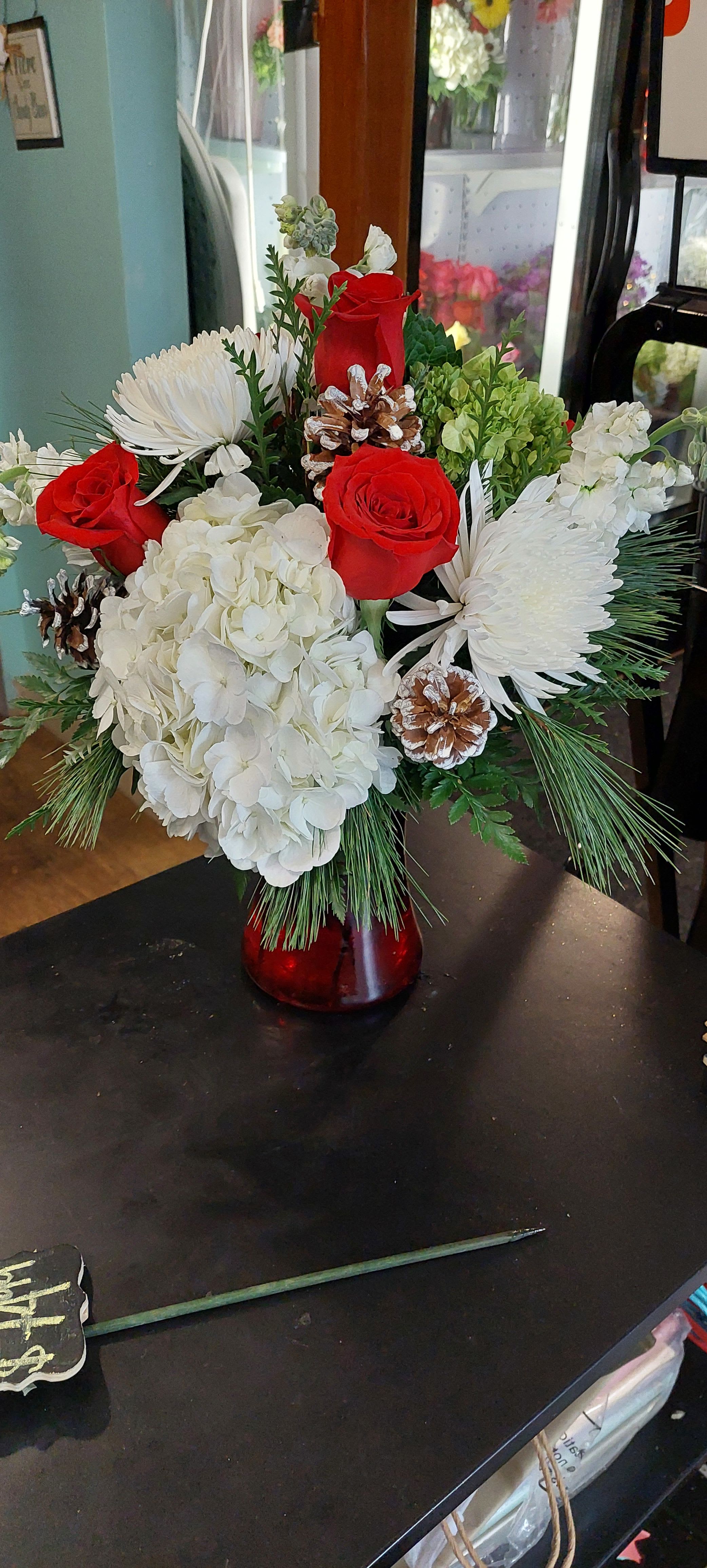 Christmas Gathering - Seasonal flowers in a holiday gathering vase