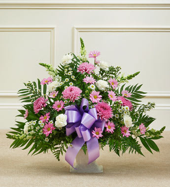 Lavender &amp; White Tribute Funeral Basket - Expressing all the love you feel in your heart during times of loss is not always easy. This delicate floor basket arrangement helps you convey your care and concern with beautiful lavender flowers to represent a vibrant life, and fresh, white blooms to symbolize purity and peace.