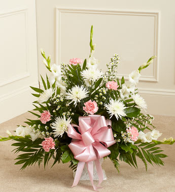 Pink &amp; White Tribute Funeral Basket - When words aren’t enough to convey all you feel at this difficult time, let our beautiful floor basket arrangement help you express your feelings perfectly. With pink flowers to symbolize admiration and appreciation for a life well lived and white flowers to symbolize peace and respect, this gathering of fresh roses, snapdragons, carnations and more brings beauty and hope to a difficult time.