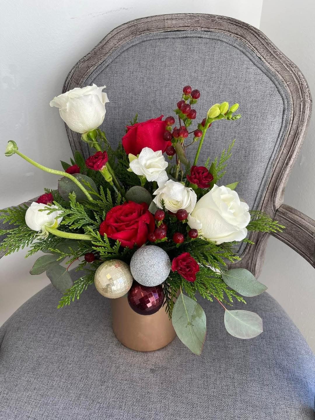 Luxury Christmas Floral Gift  - Celebrate the magic of the season with our Luxury Christmas Floral Gift, a stunning white-and-red arrangement crafted to bring elegance and joy to any holiday setting. Lush red roses, pristine white blooms, and festive seasonal accents come together in a rich, luxurious display that captures the warmth and wonder of Christmas. Expertly designed for a sophisticated look, this arrangement blends classic holiday colors with premium textures—perfect as a centerpiece, a heartfelt gift, or a statement piece to elevate your holiday décor. Whether you’re surprising someone special or adding festive charm to your own home, this exquisite design delivers timeless beauty and Christmas cheer.