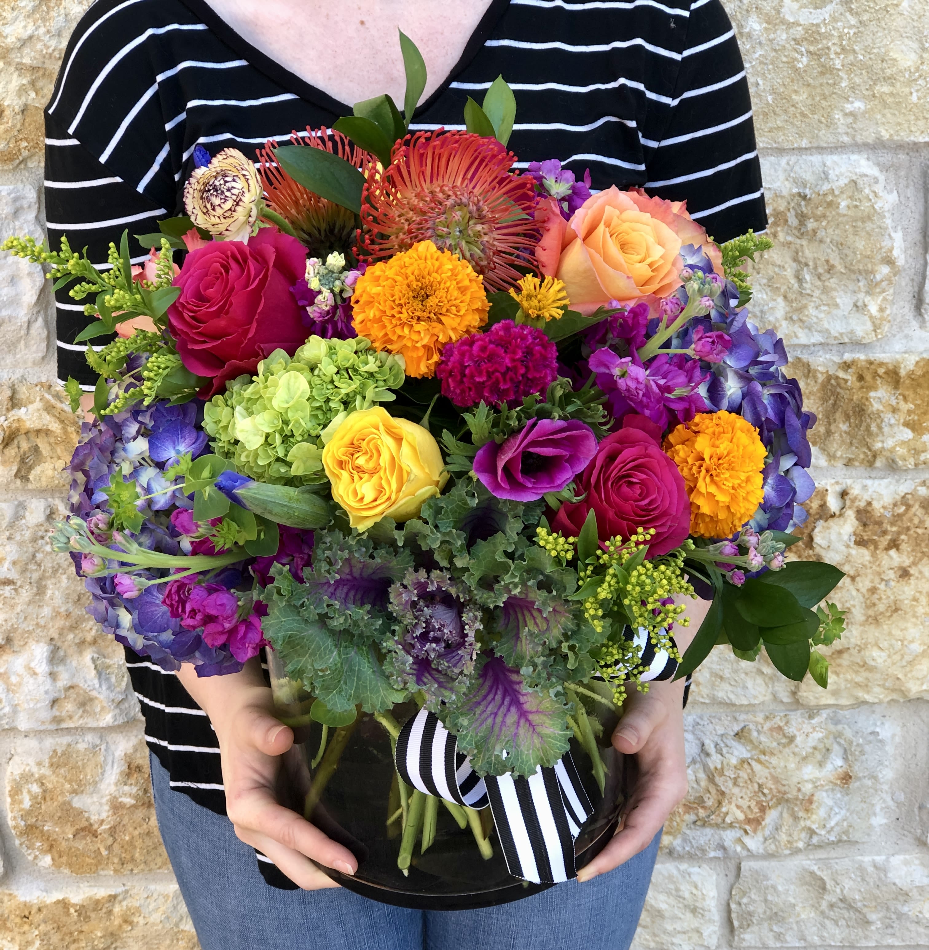 Lavish Vibrant Garden - A lavish seasonal arrangement, with our most premium floral varieties in bright, vibrant shades. Designed in our signature English Garden style and delivered in a clear glass vase.  Overall design is approximately 16"x16" Floral varieties may vary but will be of similar quality and style.  