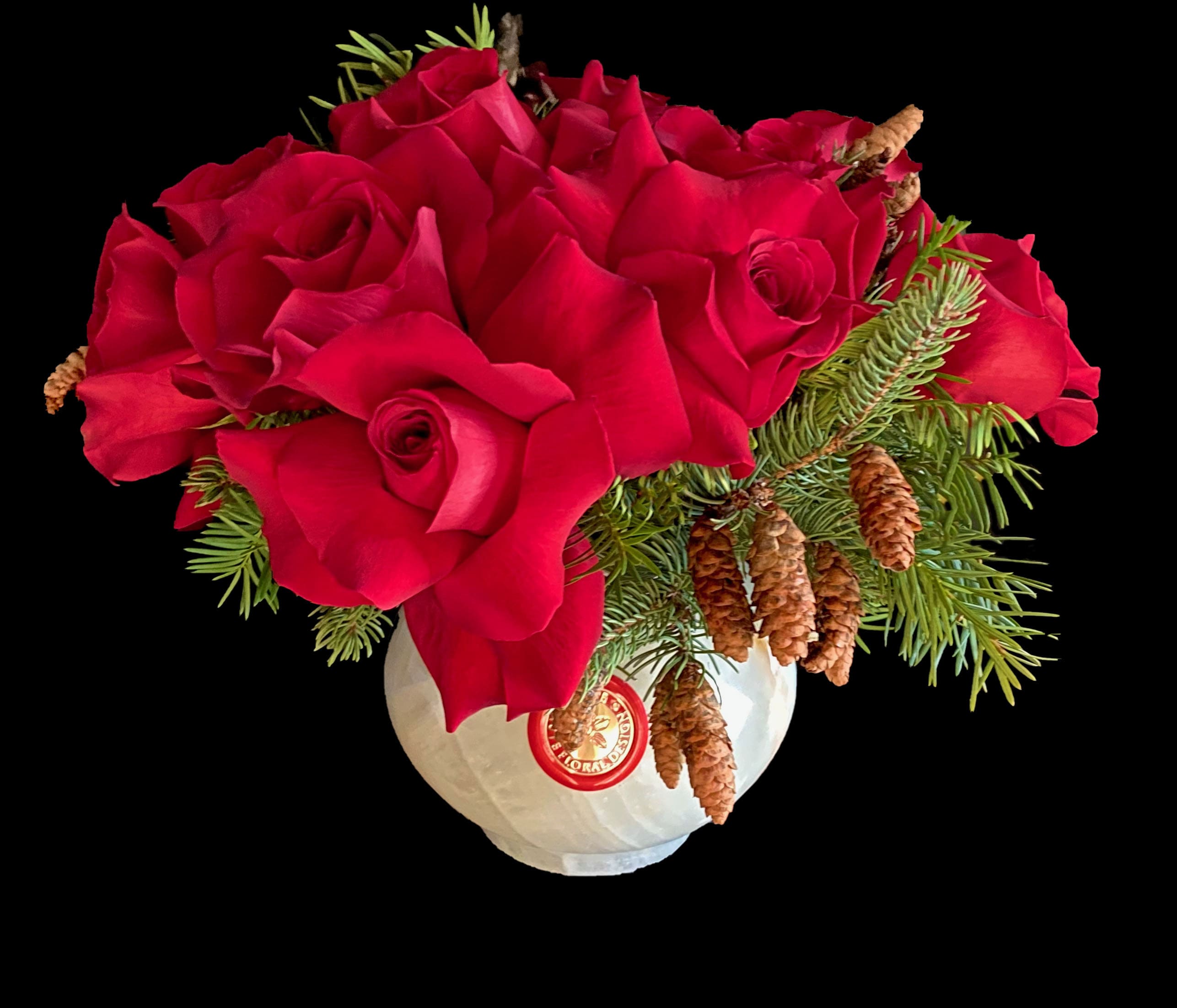 Naughty - Onyx container with seasonal foliage and red roses.