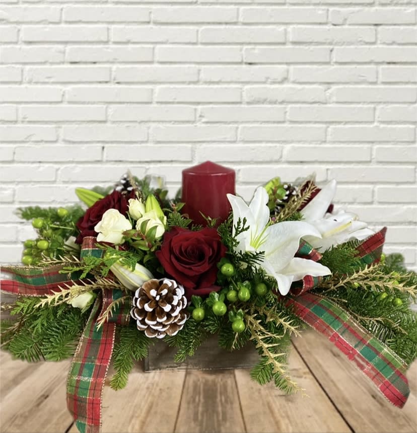 Cedar &amp; Chestnut  - This red pillar centerpiece in wood box keepsake featuring frosted pinecones, plaid ribbon, white lilies, red roses, etc. 