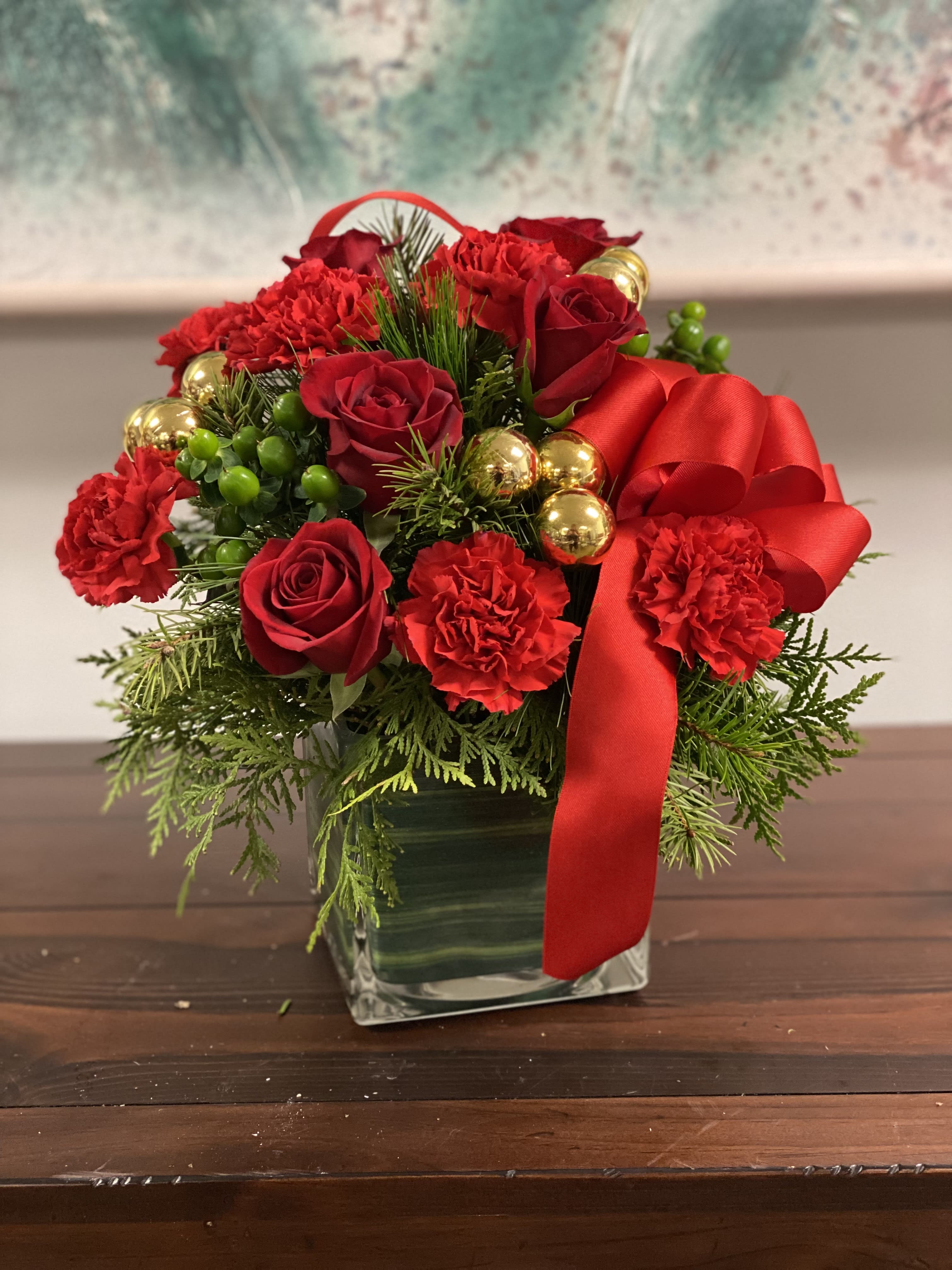 Believe - You may not be able to guarantee a white Christmas but with elegant touches like stunning red roses mixed with ornament balls and douglas fir you can be assured of sending a merry and bright one!