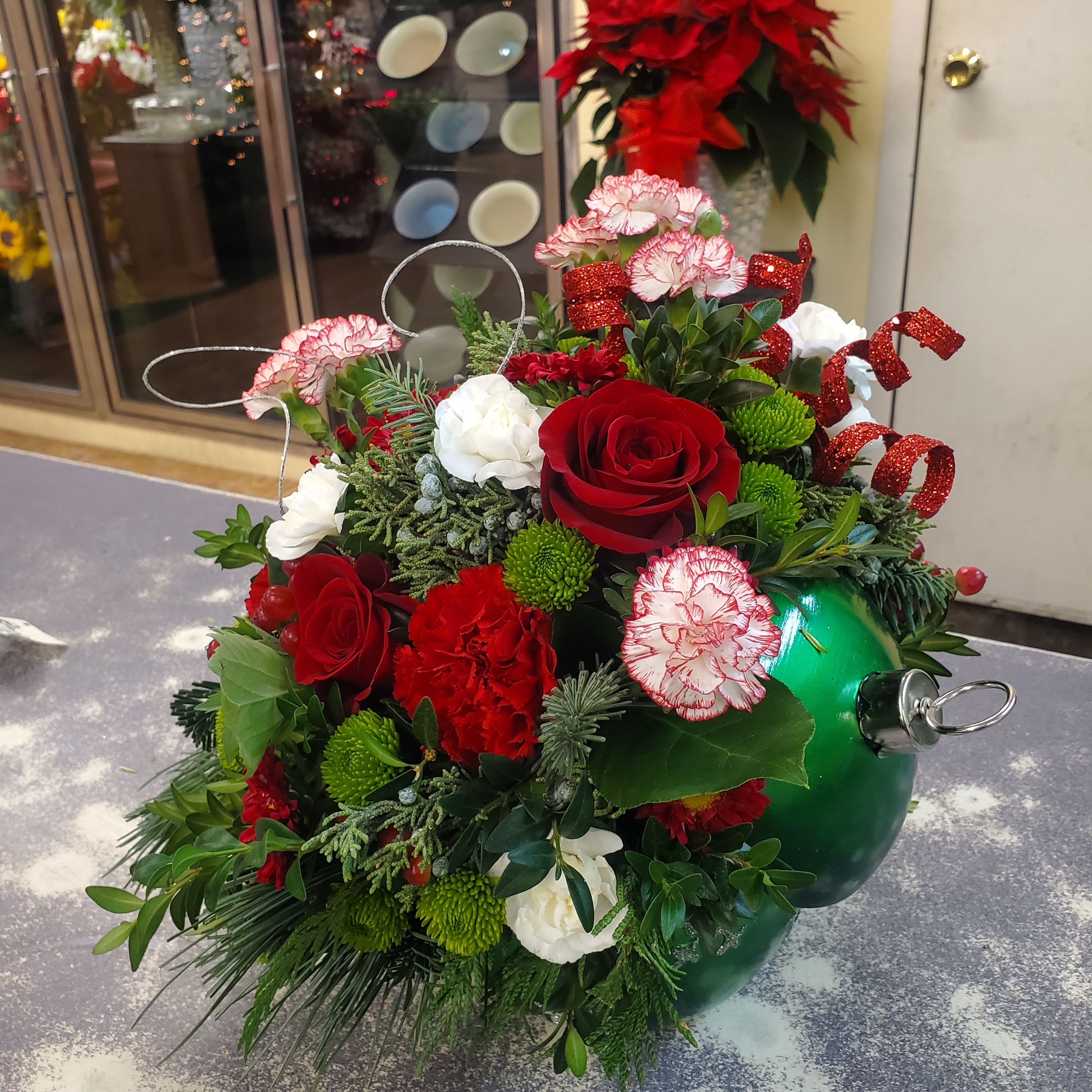 Ornament Bouquet  - Ceramic container filled with seasonal flowers and winter greens accented with glass balls.  **Design, Flower Selection and Colors will vary **.