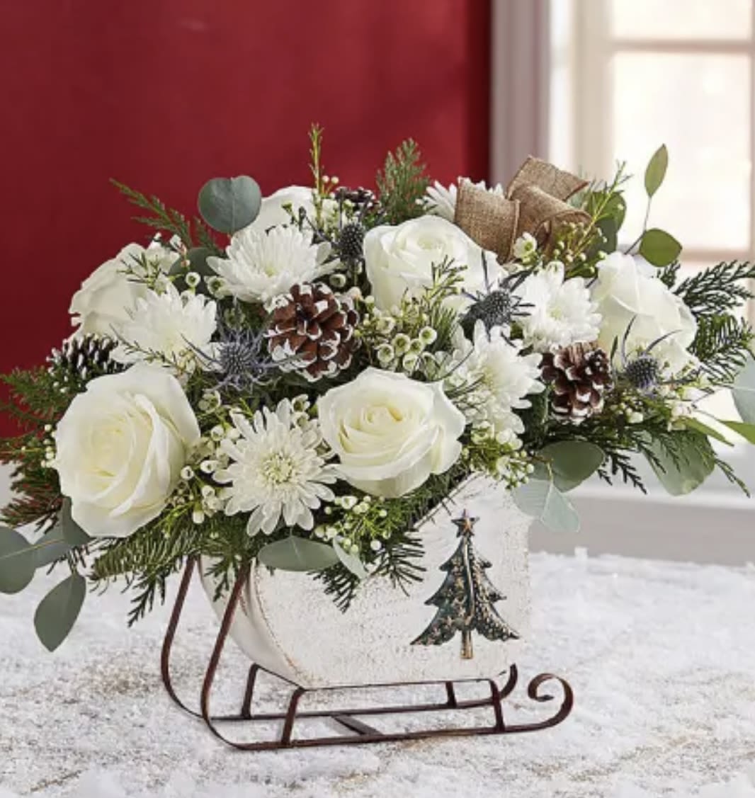 Santa’s Sleigh  - Beautiful sleigh arrangement with variety of Christmas greenery roses and more. 