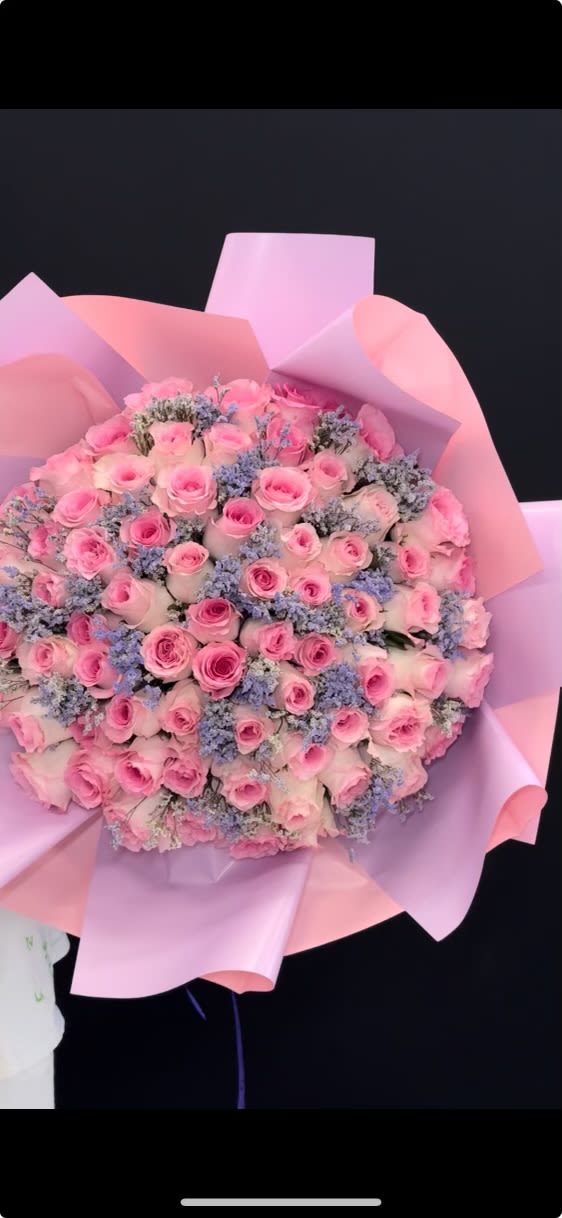 Deluxe Bouquet (Large Size – Designer’s Choice) - A breathtaking, oversized bouquet created with premium pink roses and soft lavender fillers, wrapped in luxury pink paper for a dreamy, romantic look. This bouquet is designed to impress — perfect for birthdays, anniversaries, proposals, or any special surprise.   Please note: Each bouquet is handcrafted and flowers may vary slightly based on availability, but the size, fullness, will always stay the same.