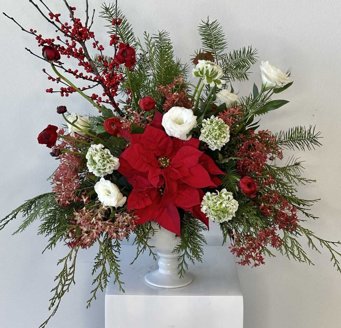 Noël by Fleurs de Mad - Celebrate the magic of the holidays with Noël, a luxurious Christmas-themed floral arrangement from Flower Synergy in Costa Mesa. Designed to bring warmth, color, and festive elegance to any space, this handcrafted bouquet features a rich blend of poinsettia, ranunculus, lisianthus, and vibrant ilex berries. Each stem is thoughtfully selected to capture the spirit of the season while offering a refined, modern holiday aesthetic.  Perfect for holiday gifting, Christmas parties, winter celebrations, or elevating your seasonal décor, Noël combines classic Christmas elements with premium florist design. Its lush textures, warm tones, and festive details make it a standout centerpiece for dining tables, entryways, or as a heartfelt gift for loved ones.  Created with care by our skilled designers in Costa Mesa, this arrangement highlights the beauty of fresh, high-quality blooms and the timeless charm of holiday traditions. Noël is ideal for anyone seeking a unique Christmas arrangement that feels elegant, joyful, and unmistakably festive.  Order Noël from Flower Synergy for Christmas delivery in Costa Mesa and surrounding Orange County areas. Let this seasonal bouquet bring holiday cheer and unforgettable style to your celebrations.