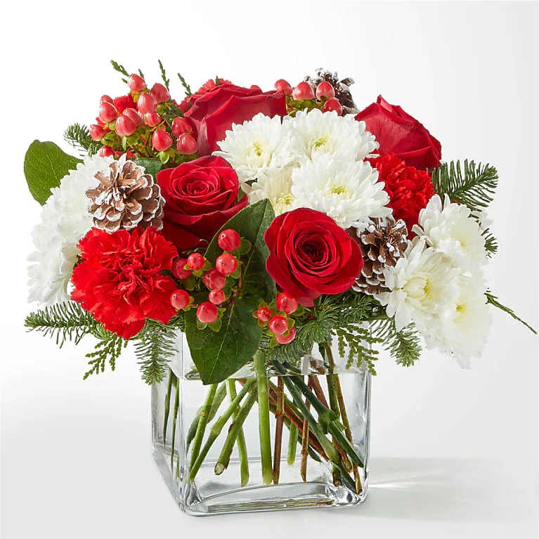 Snow Angel Cube - Snow Angel Bouquet A delicate balance of red and white florals accented with seasonal greens to brighten their day.