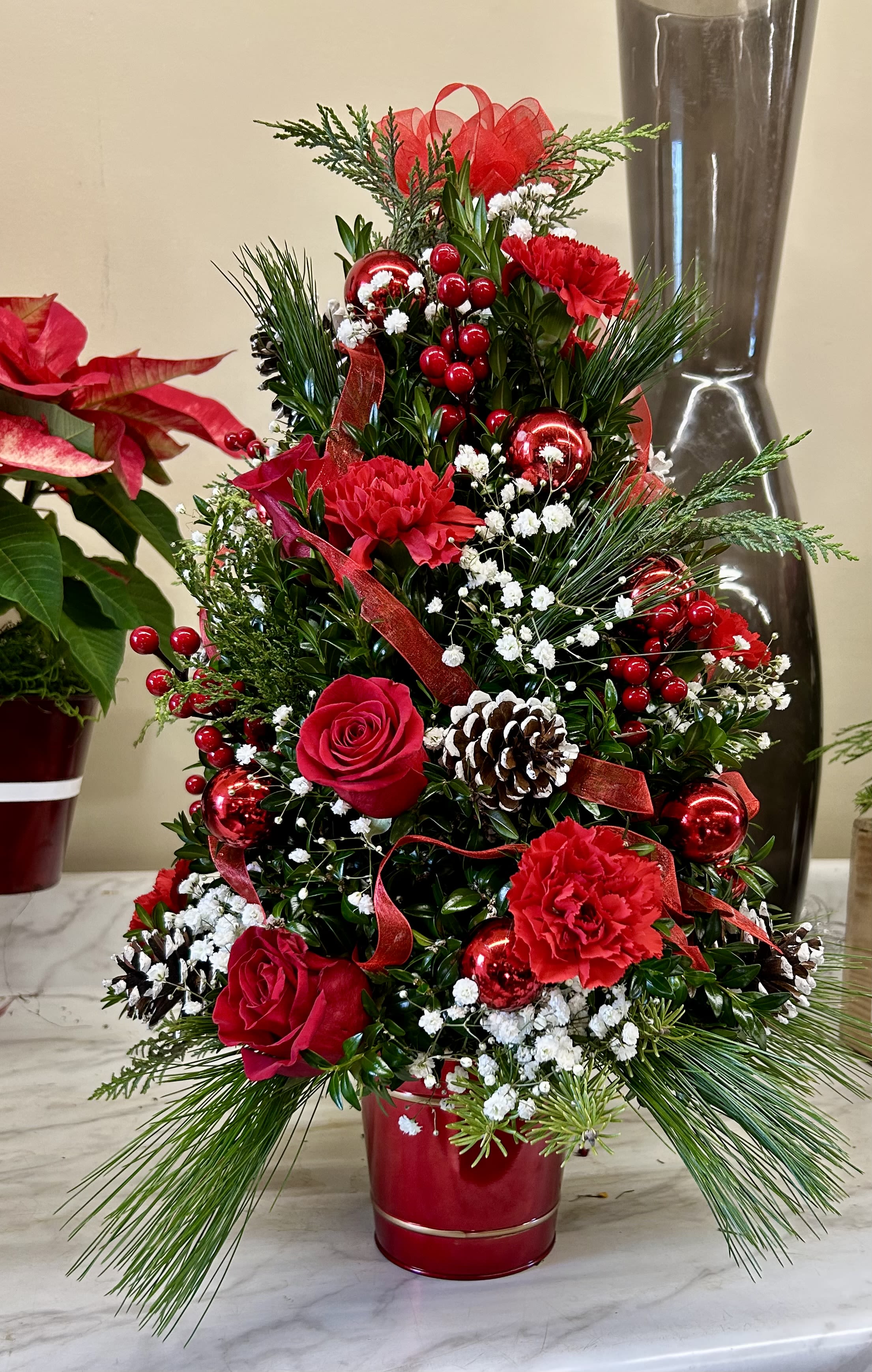Boxwood and mixed green tree - Christmas tree shaped arrangement with mixed red and white flowers, pinecones, and Christmas balls