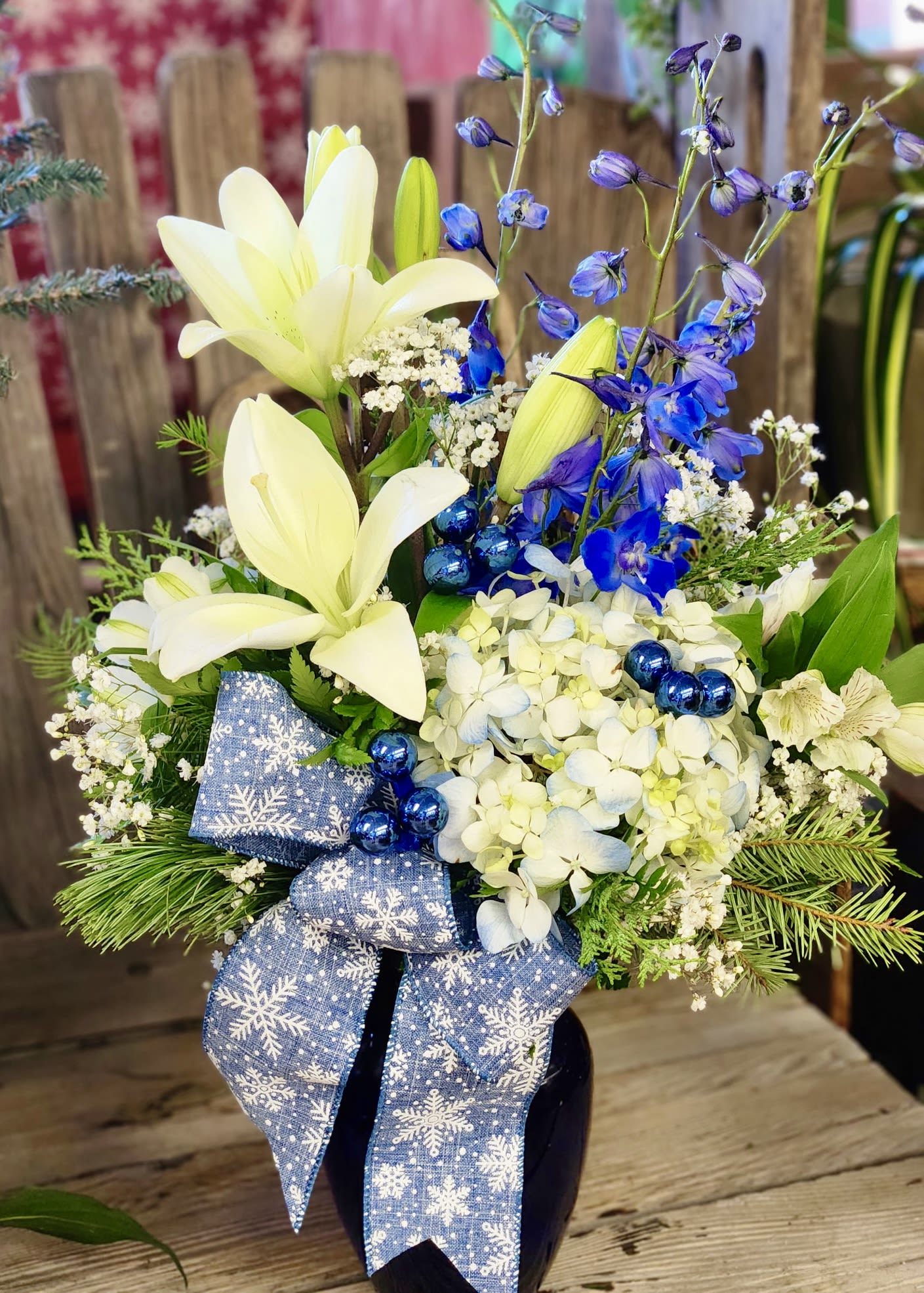 Frosted Blue Bouquet - A modern blue-and-white holiday arrangement featuring white Asiatic lilies, blue hydrangea, and deep blue delphinium. Perfect for Hanukkah décor, winter celebrations, or elegant seasonal gifting. Fresh, serene, and beautifully festive.