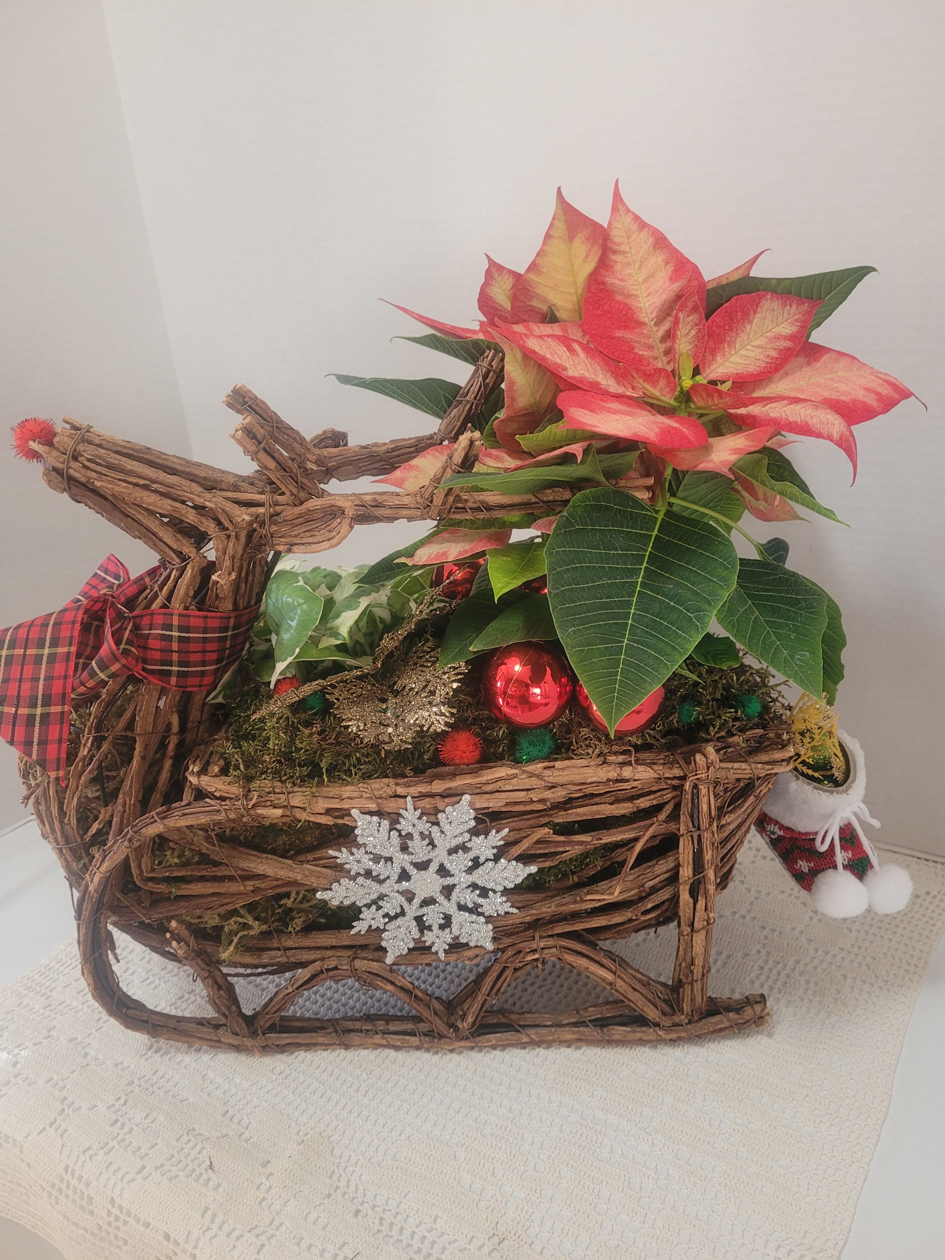 Reindeer #3 - A festive wicker reindeer featuring holiday colors and faux embellishments. It will be a touch of whimsy on your table. 