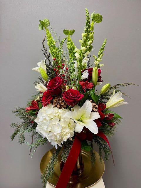 GRAND ENTRANCE - This tall glass vase filled with specialty flowers such as hydrangea, lilies, roses, adorned by winter greens &amp; ribbons will be sure to make a a grand entrance anywhere!