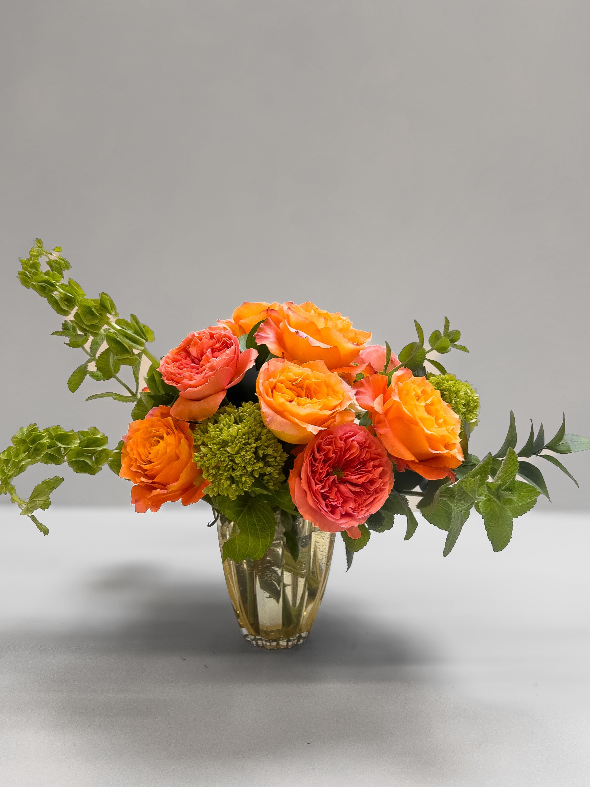 Mandarin Medley - Glowing with citrusy warmth, this arrangement features bold and bright roses. Like a summer sunset in a vase, it brings natural beauty to any space.