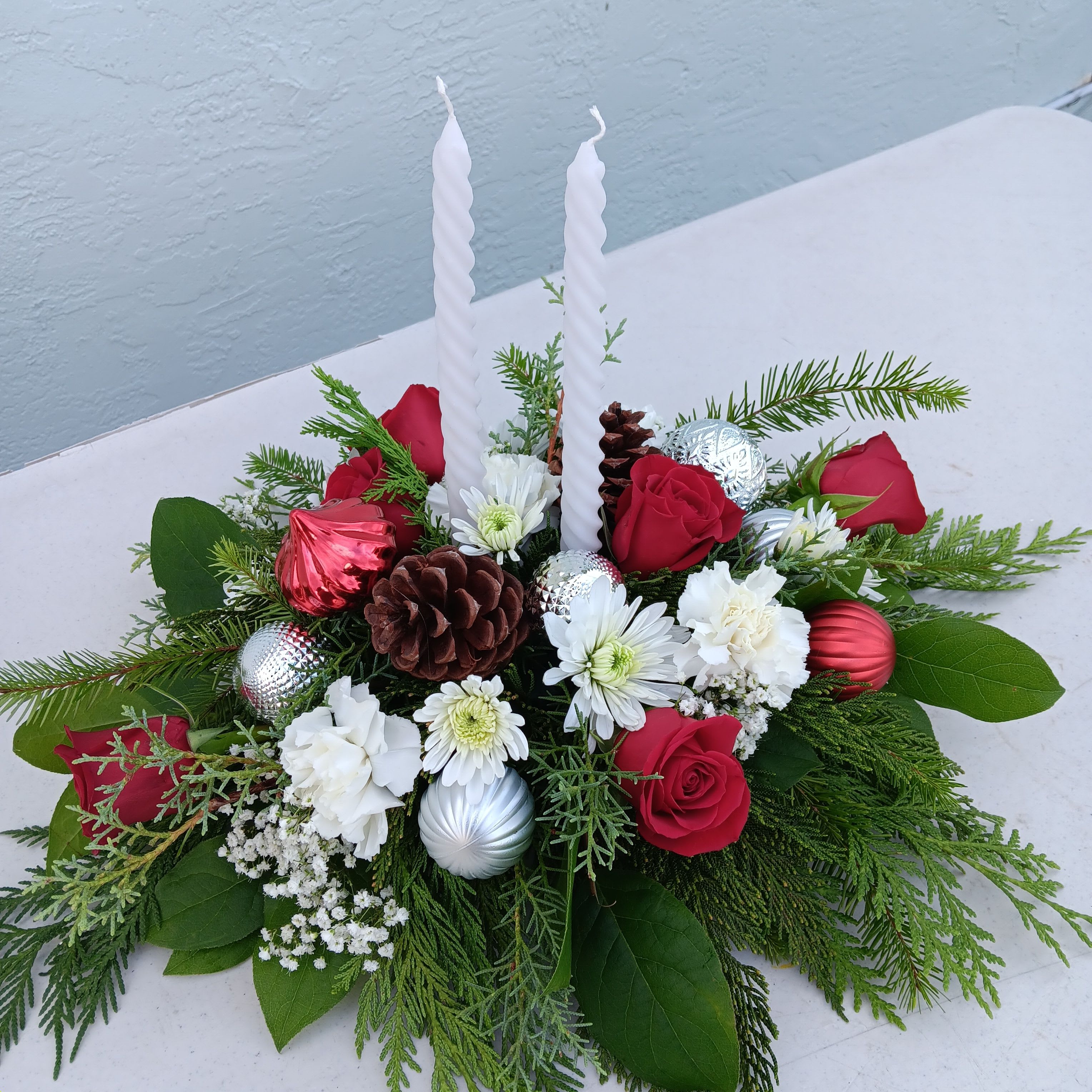 Evergreen Charm - Holliday centerpiece with candles in red, white and silver theme.