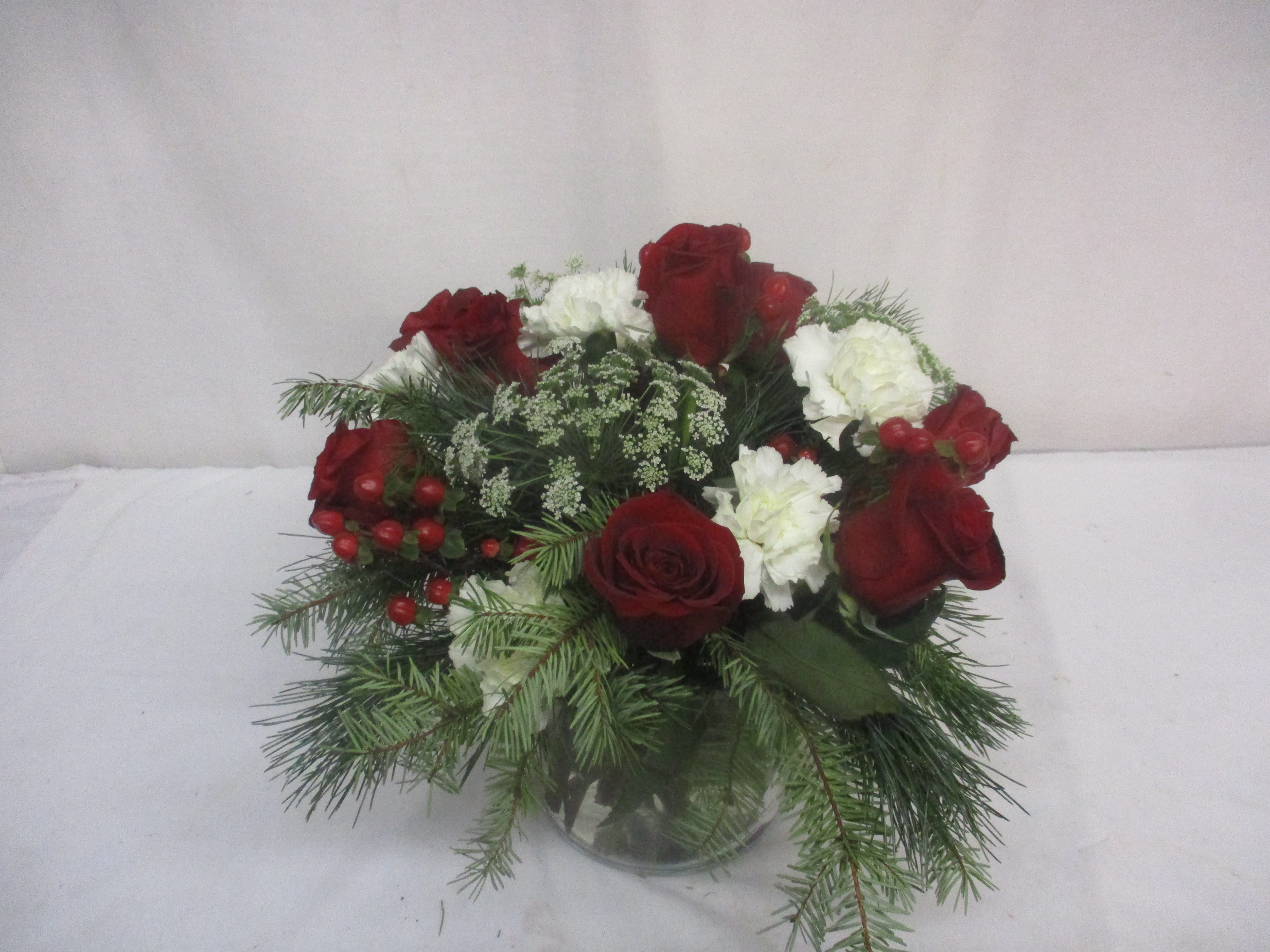 Festive Holiday Wishes - What’s the best part of Christmas? Flowers. That’s the answer. If you’re skeptical, let us prove it to you. Order the Festive Holiday Wishes arrangement today and add a whole new, flowery dimension to your holiday.