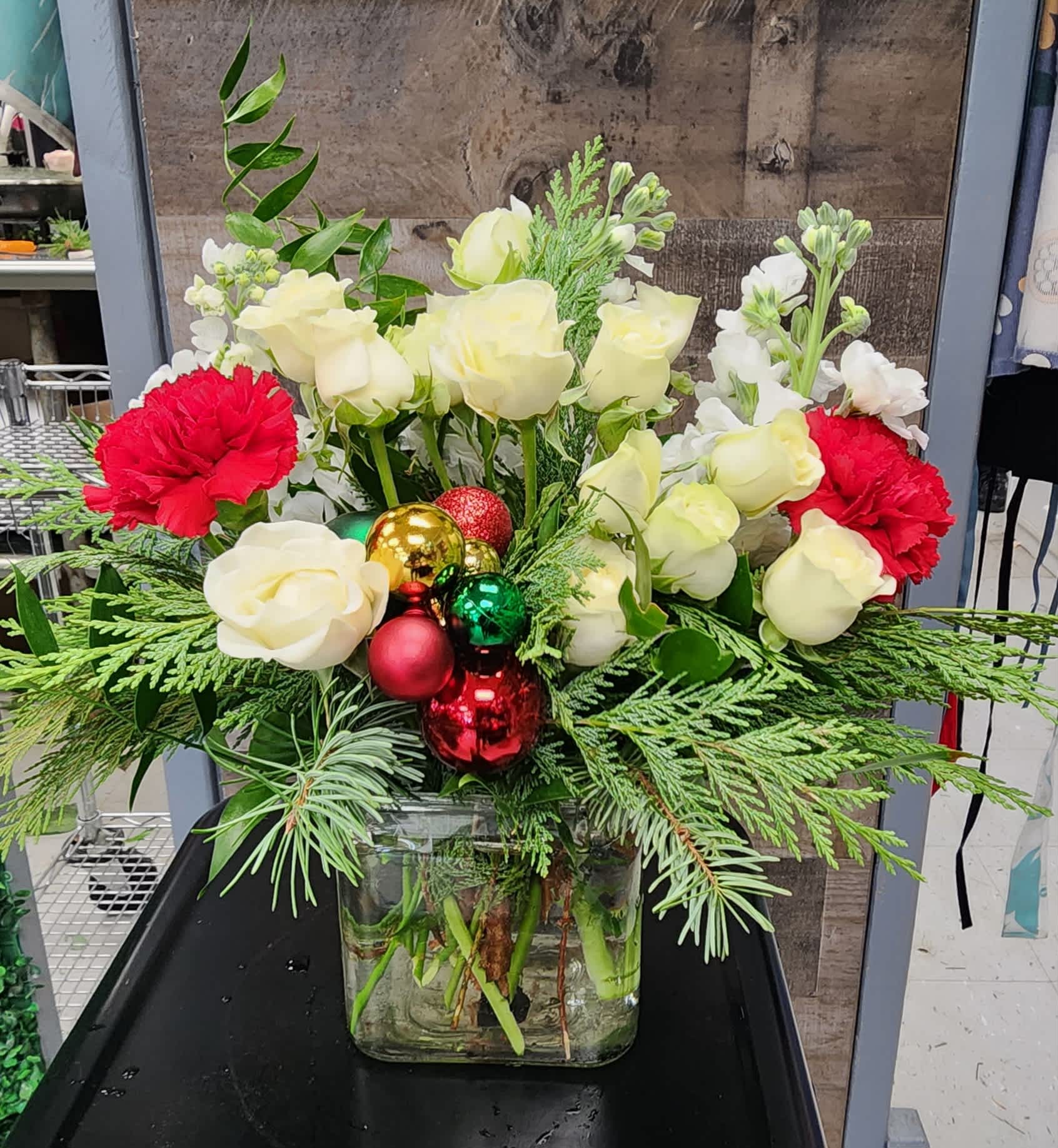 Festive and Fun - A festive fun arrangement filled with white spray roses, red carnations, and white stock.
