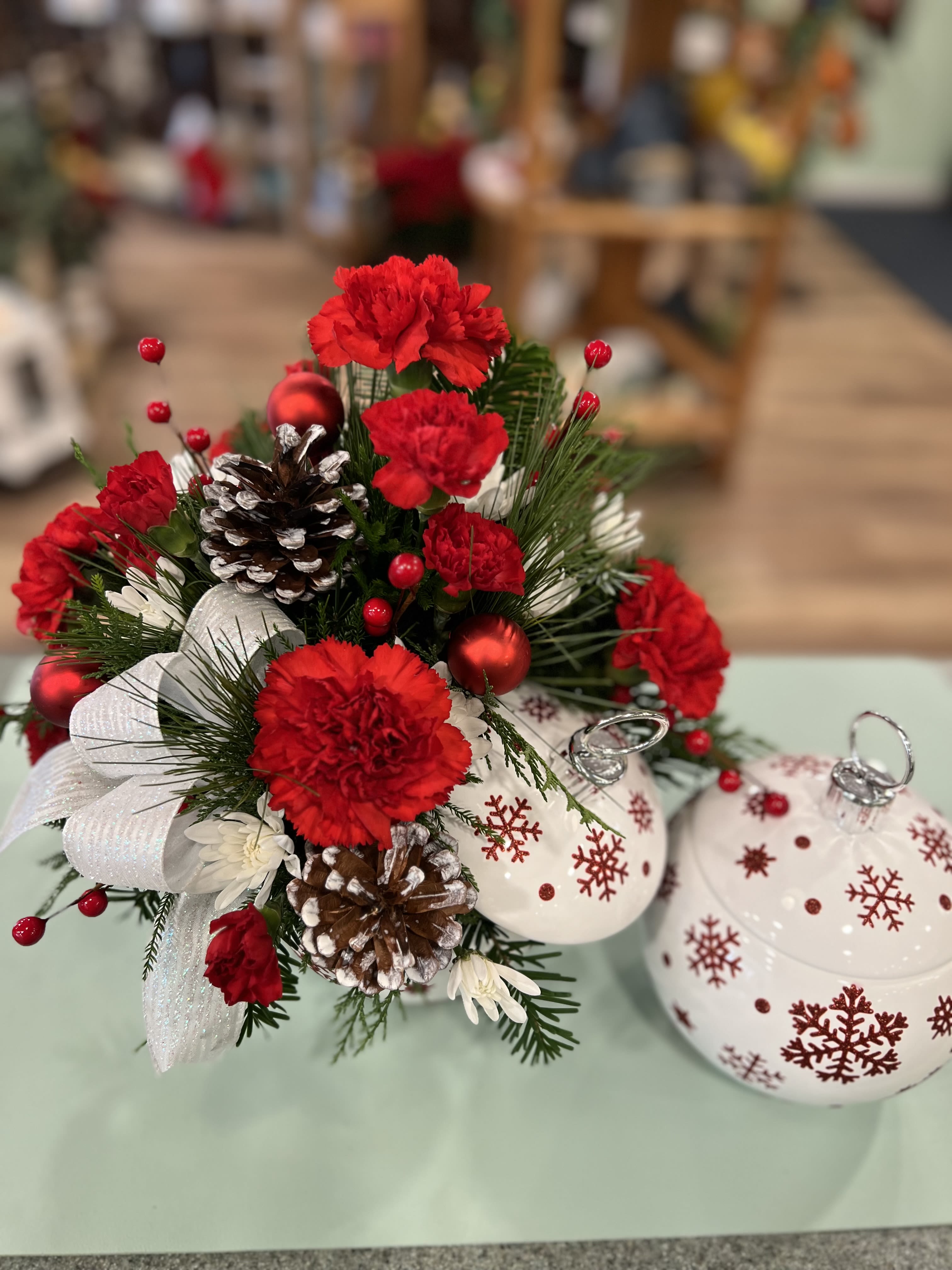 Sprinkle Sparkle Bouquet (SNO) - Brighten your Christmas with a bouquet of vibrant red roses and winter greens, beautifully arranged in a hand-painted ceramic ornament jar with sparkling stars. It's perfect for holding wrapped candies and holiday treats for years to come!