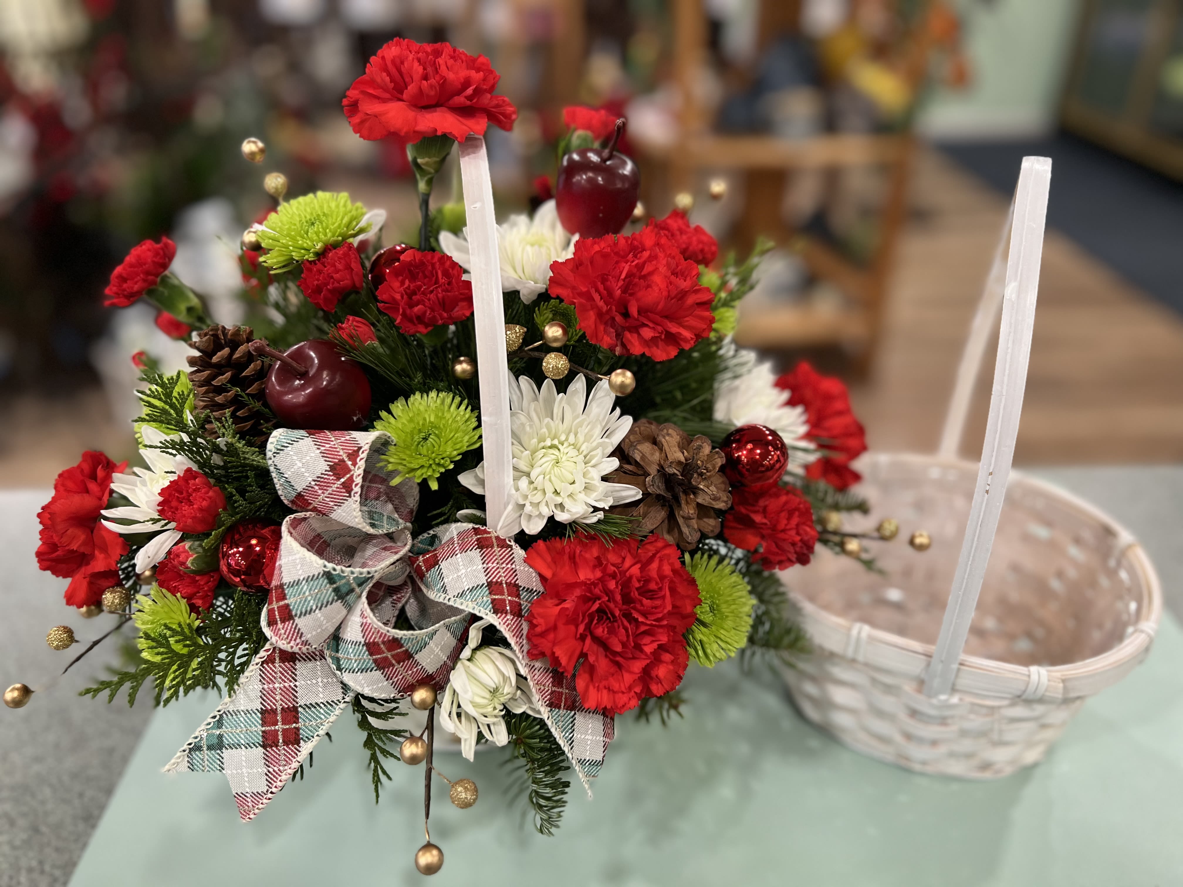 Country Holiday Basket (CHB) - Christmas with a touch of natural country!  Red, White and green flowers with Berries, pinecones, ribbons and more make up this holiday basket.