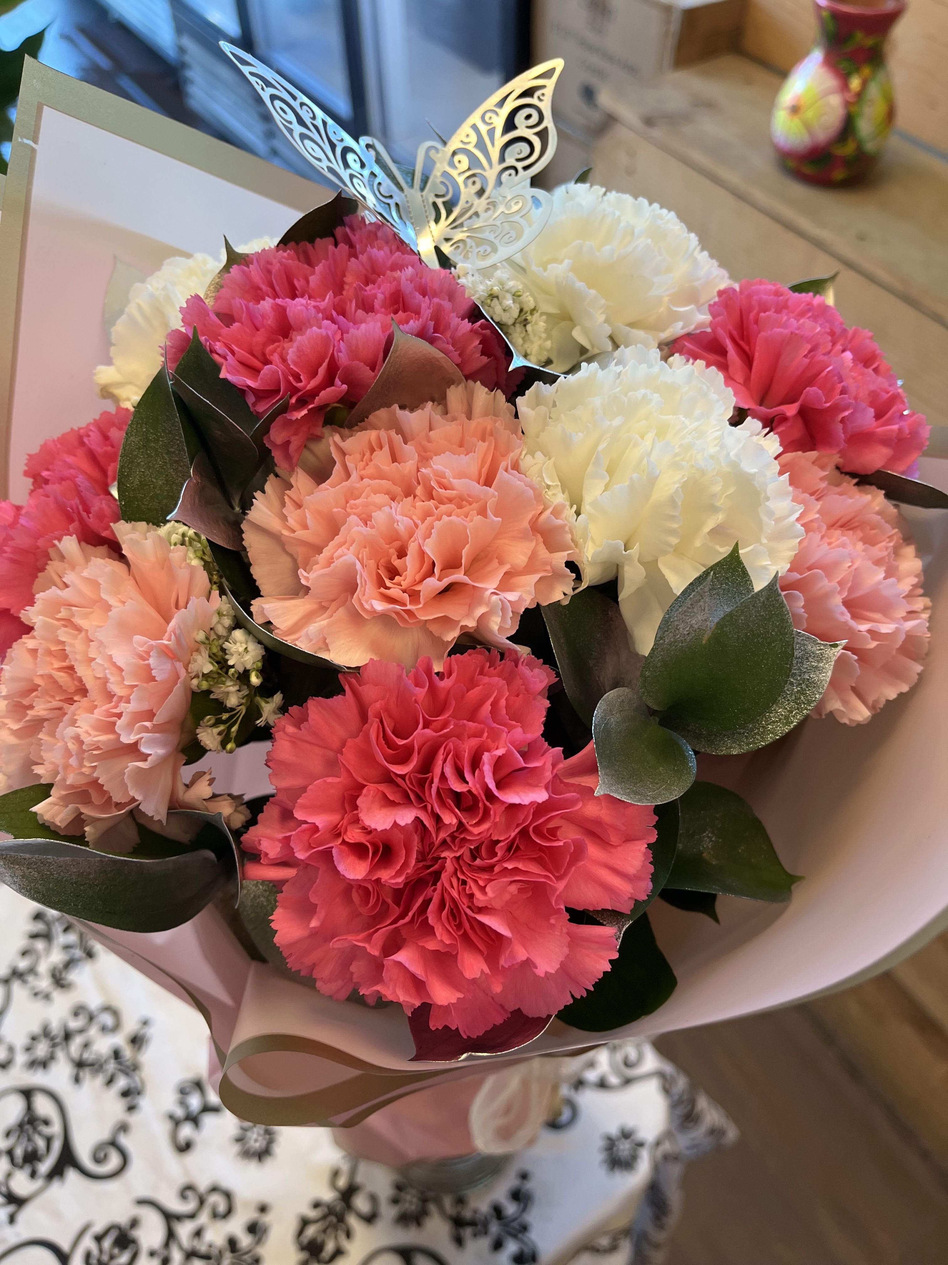 Pink Love Carnation Wrap (No Vase) - 15 Carnation in a wrap.   The carnations will be in pink, hot pink and white colors with silver ruscus and baby breath filler wrapped in beautiful Korean Paper  Deluxe includes 20 carnations Premium includes 25 carnations