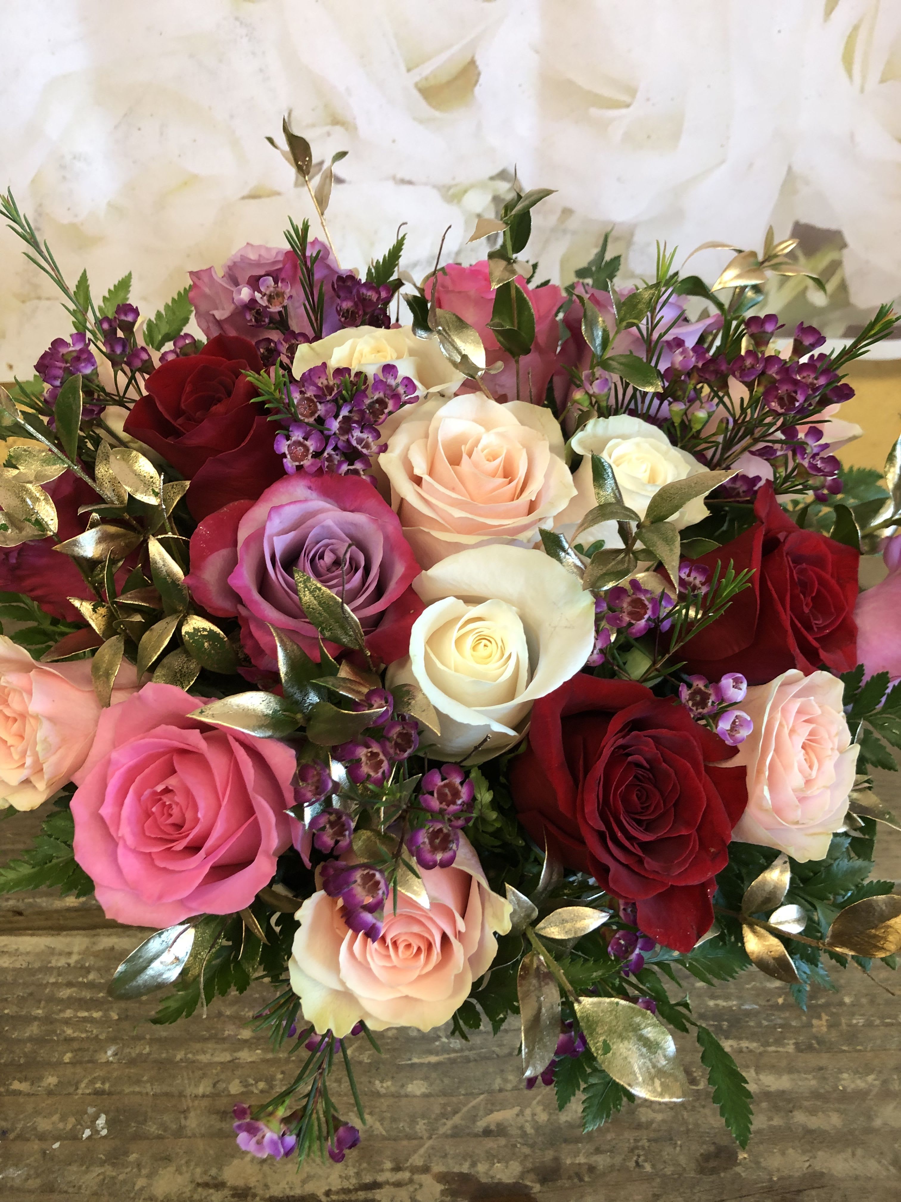 YOU HEART ME - HEART SHAPE BOX WITH ONLY ROSES AND FILLERS .  THE ROSES ARE A MIXTURE OF COLORS.  THE FILLERS ARE DESIGNER CHOICE.  FILLERS USUALLY ARE RUSCUS IN GOLD AND BABY BREATH OR WAX.  THIS IS WHITE FAKE CROCODILLE SKIN HEART BOX.  WE ADD THE LID ON TOP,  BUT IT IS NOT SECURED  AS YOU CAN SEE THE FLOWER ARE ALL STICKING OUT.  WHICH MAKES THIS ARRANGEMENT FULLER.     STANDARD INCLUDES 18 ROSES   DELUXE INCLUDES 24 ROSES PREMIUM INCLUDES 32 ROSE 