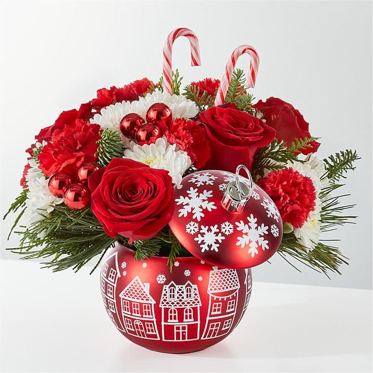 Cheer in the Air Ornament - Bursting holiday spirit is elegantly symbolized in this deep red bouquet, where carnations, roses and alstroemerias explode from a keepsake ceramic ornament vase.