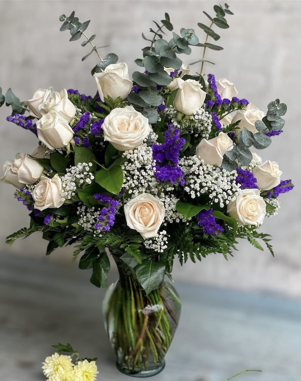 ROSE ELEGANCE - White roses are an elegant surprise for someone who brings pure joy to your life. Beautifully arranged by our expert florist with lush greenery inside a classic glass vase 24 delicate blooms are hand- delivered and ready to delight the people you care about for big celebrations.
