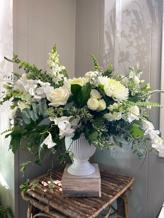 Sweet Sympathy - This elegant, garden-styled arrangement of all white roses, dendrobium orchids, snapdragons, and more makes for a sweet gesture of sympathy.