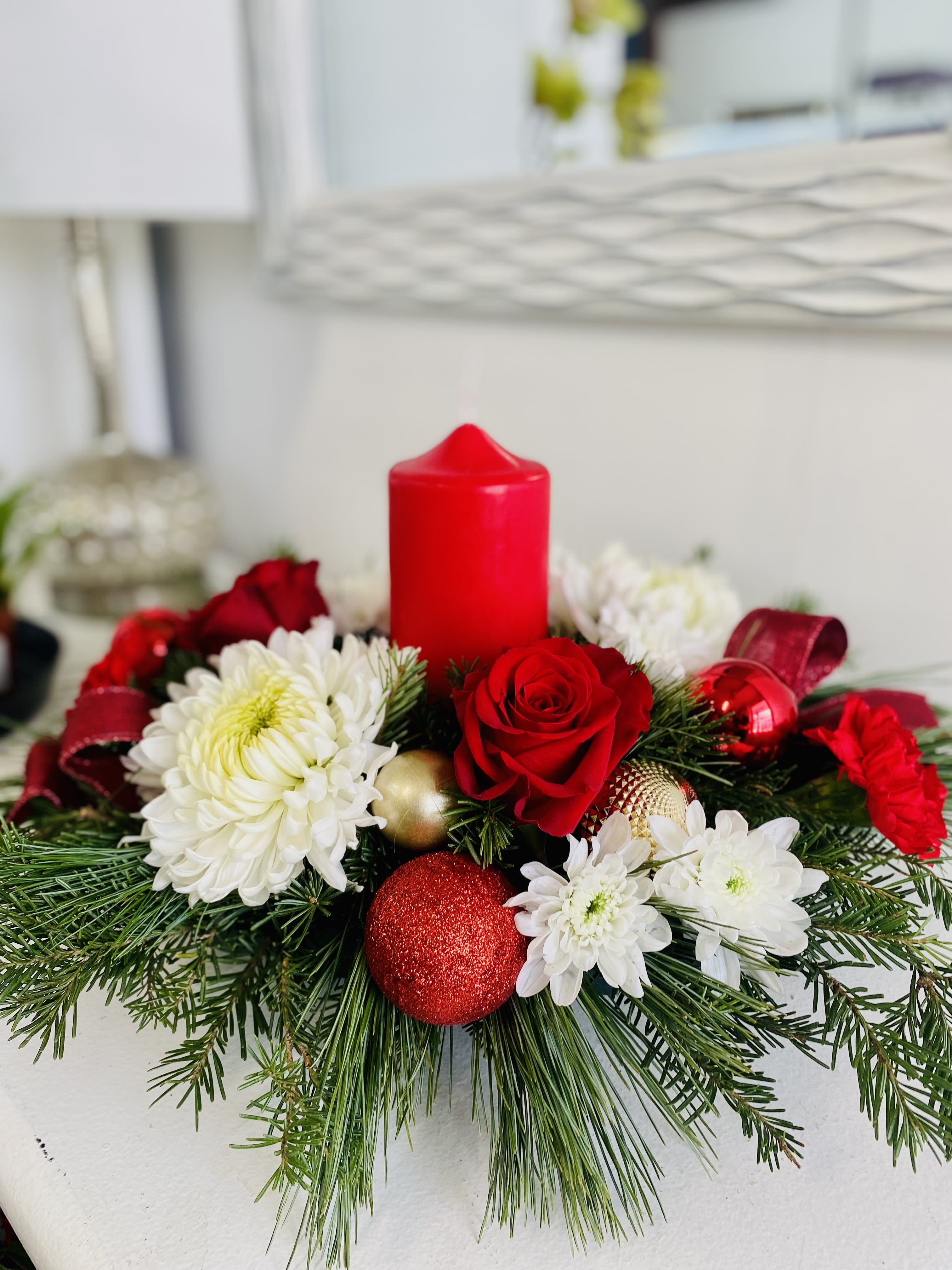  Christmas #1 - Christmas table center with pillar candle, fresh scented greens and long lasting flowers in reds and whites.