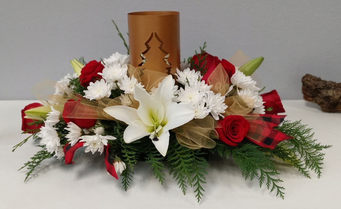 Merry Christmas Votive Candle Centerpiece - This beautiful centerpiece features a gold Christmas tree cut-out sheld that holds a cute votive candle to shed light on the season. Filled with roses, lilies, mums, and holiday greens for the season.