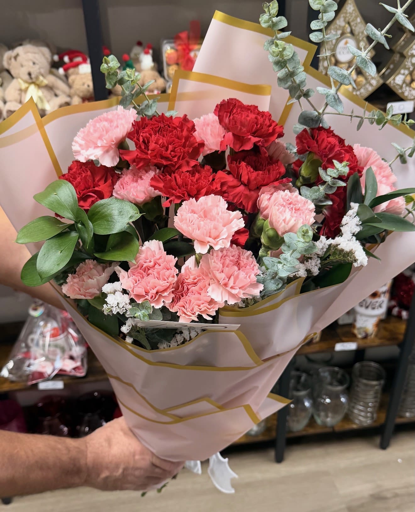 Warm Wishes Bouquet -  A beautiful hand-wrapped bouquet featuring a romantic mix of red and pink flowers, including roses, carnations, and soft seasonal accents. Styled in elegant wrap paper, this bouquet is perfect for anniversaries, birthdays, Valentine’s Day, or any moment when you want to show love and appreciation. Fresh, charming, and thoughtfully arranged for a heartfelt gift.