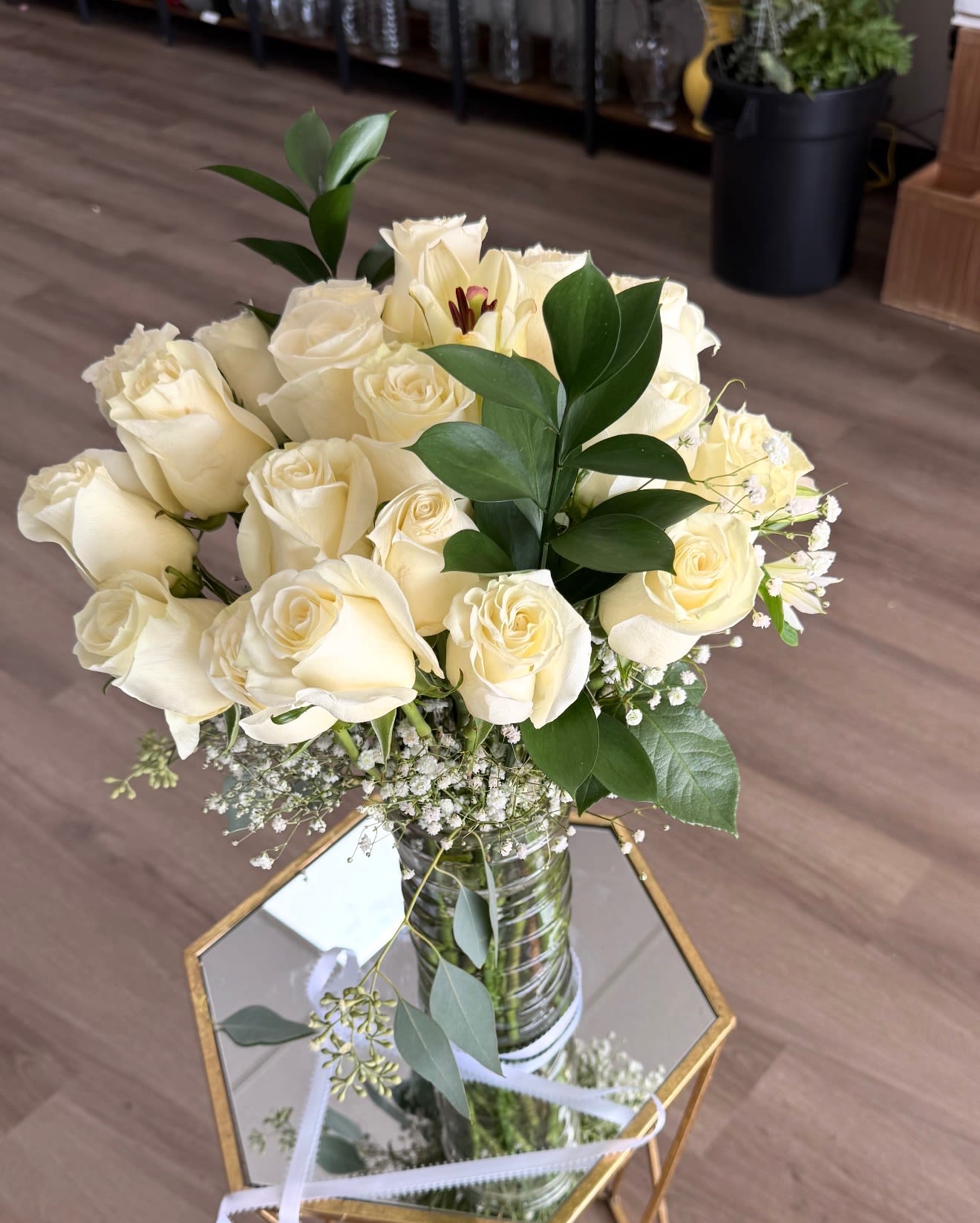  Pure Elegance Roses - This stunning arrangement showcases a luxurious bundle of fresh white roses, paired with delicate baby’s breath and lush greenery for a soft, timeless look. Designed in a tall clear vase, it brings an elegant and serene presence to any space. Perfect for anniversaries, sympathy gestures, weddings, or any occasion that calls for pure, classic beauty.