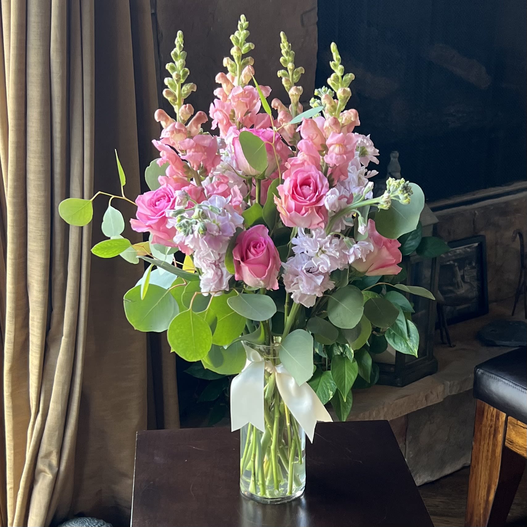 The Barbie Bouquet - Beautiful, frilly and pink! Roses, fragrant Stock and Snapdragons in cylinder vase. Perfect to perk up anyone's day. 