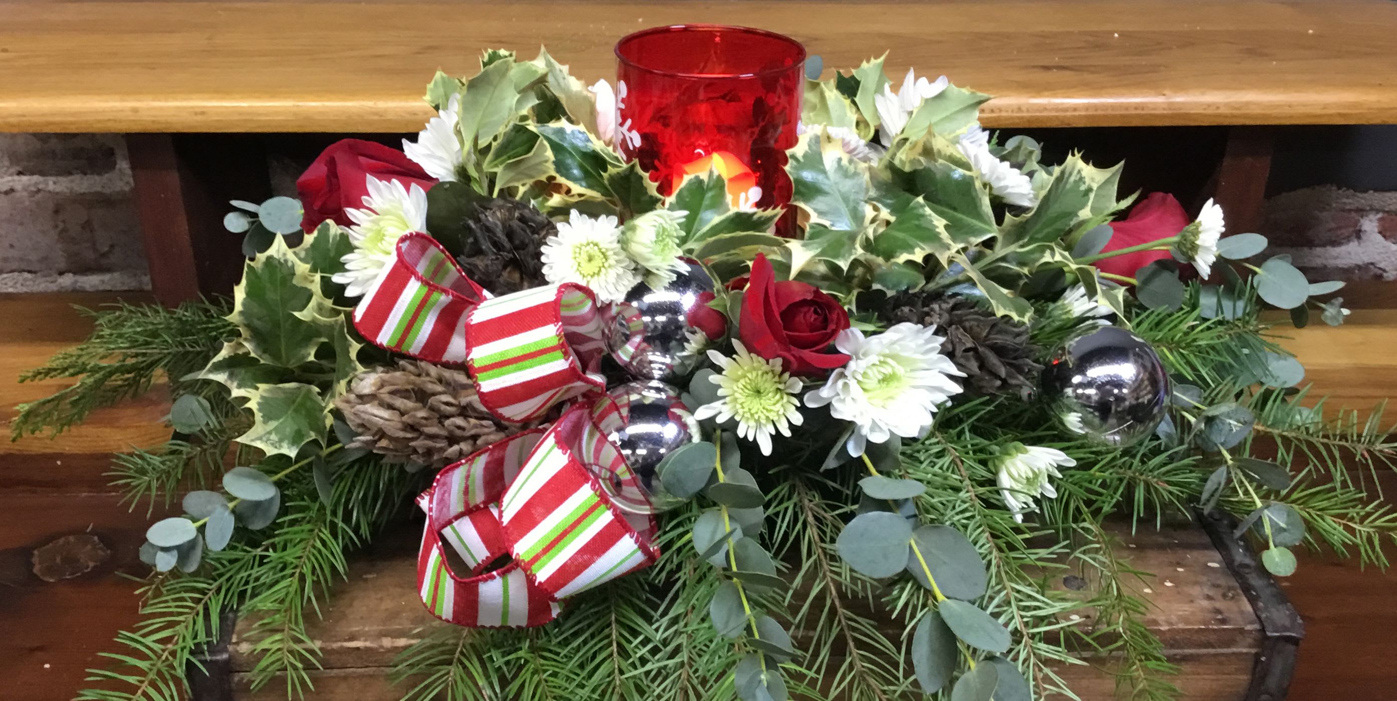 One Candle Centerpiece - Christmas Greens and flowers, Holly, and Christmas ornaments