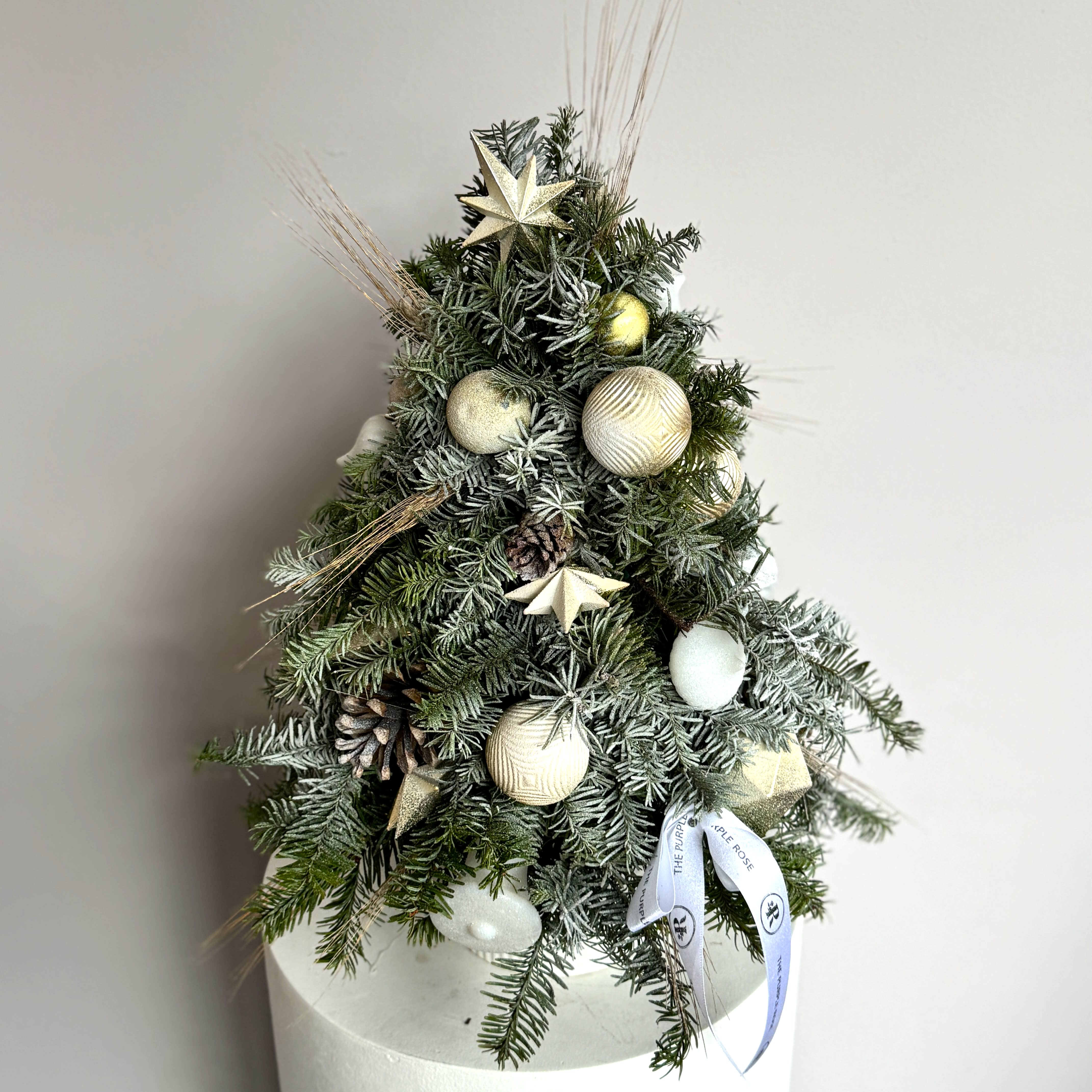 Christmas Tree - Oh Christmas Tree! This beautiful tree shaped arrangement is a fabulous gift sure to bring smiles all season long. Perfect for a friend or loved one, colleague or client - send this gift today and make it a perfect start to their Holiday season.  Christmas tree balls and decorations can be replaced with a similar one.